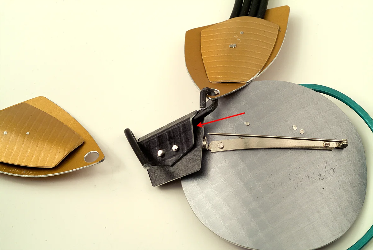 1. Open pin stem. Slide pin under black wire in the same space.