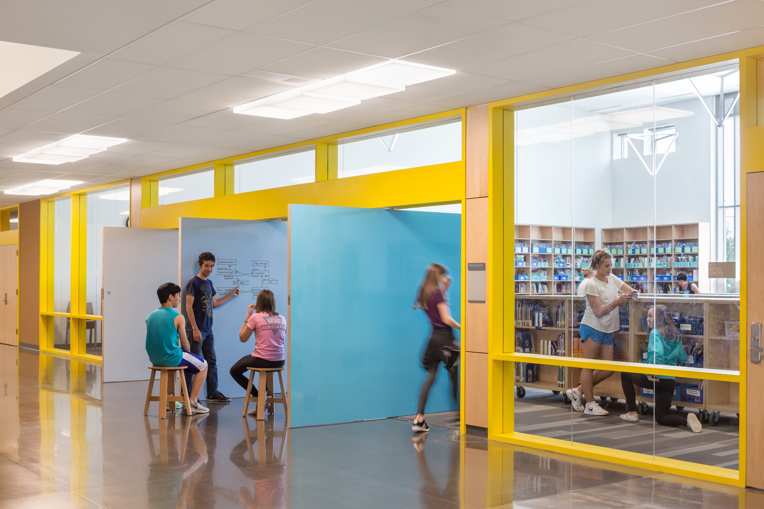Large white board swing doors extend learning beyond the classroom. Image copyright Mahlum Architects.