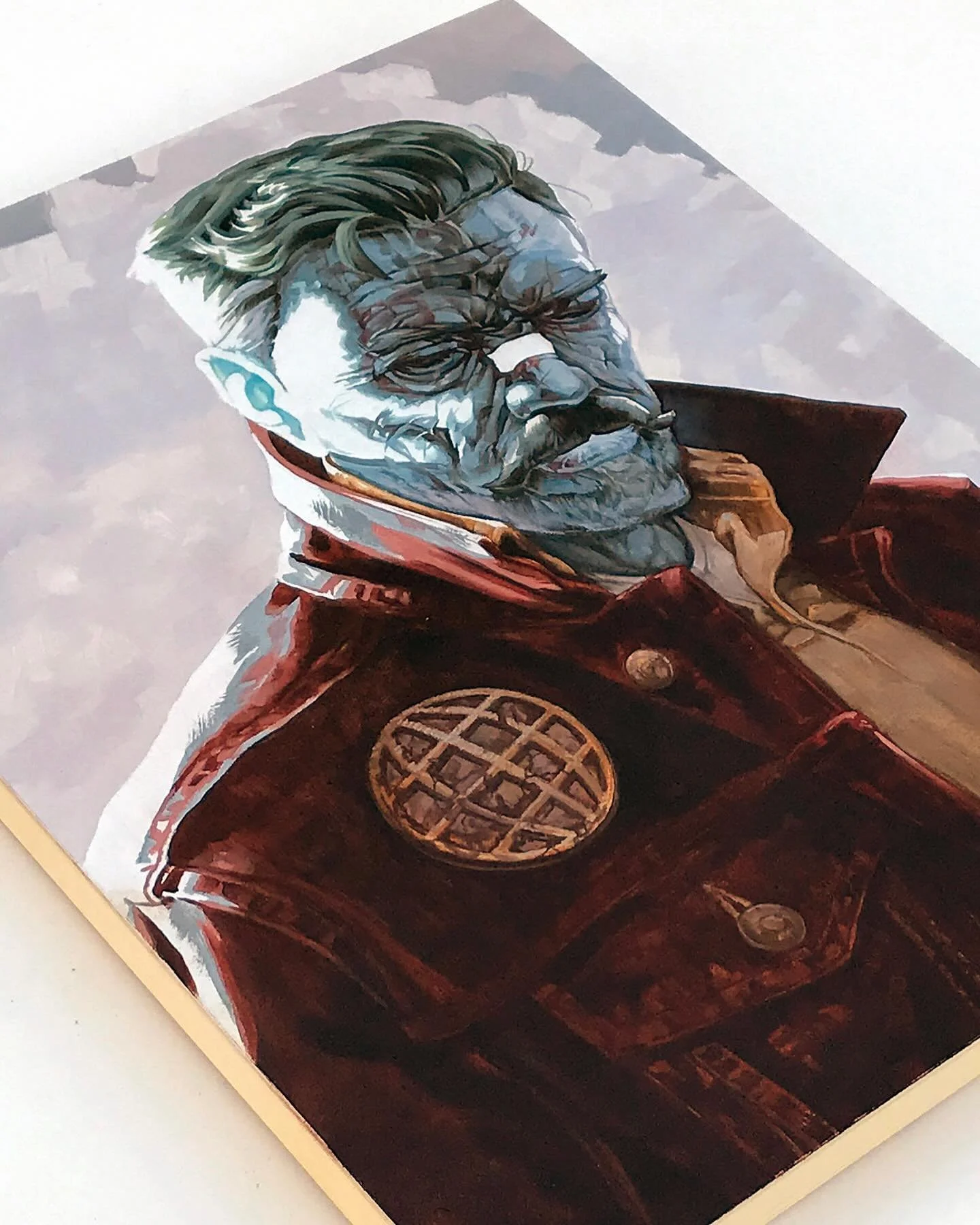 Close-up of a painting or poster depicting a man with glasses, a mustache, and styled hair, wearing a red jacket with a circular emblem on the chest, viewed from a low angle against a cloudy sky background.