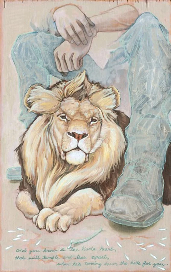 A painting of a lion lying on the ground with a person's legs and hands visible above. The lion has a calm expression. There is text at the bottom of the painting.