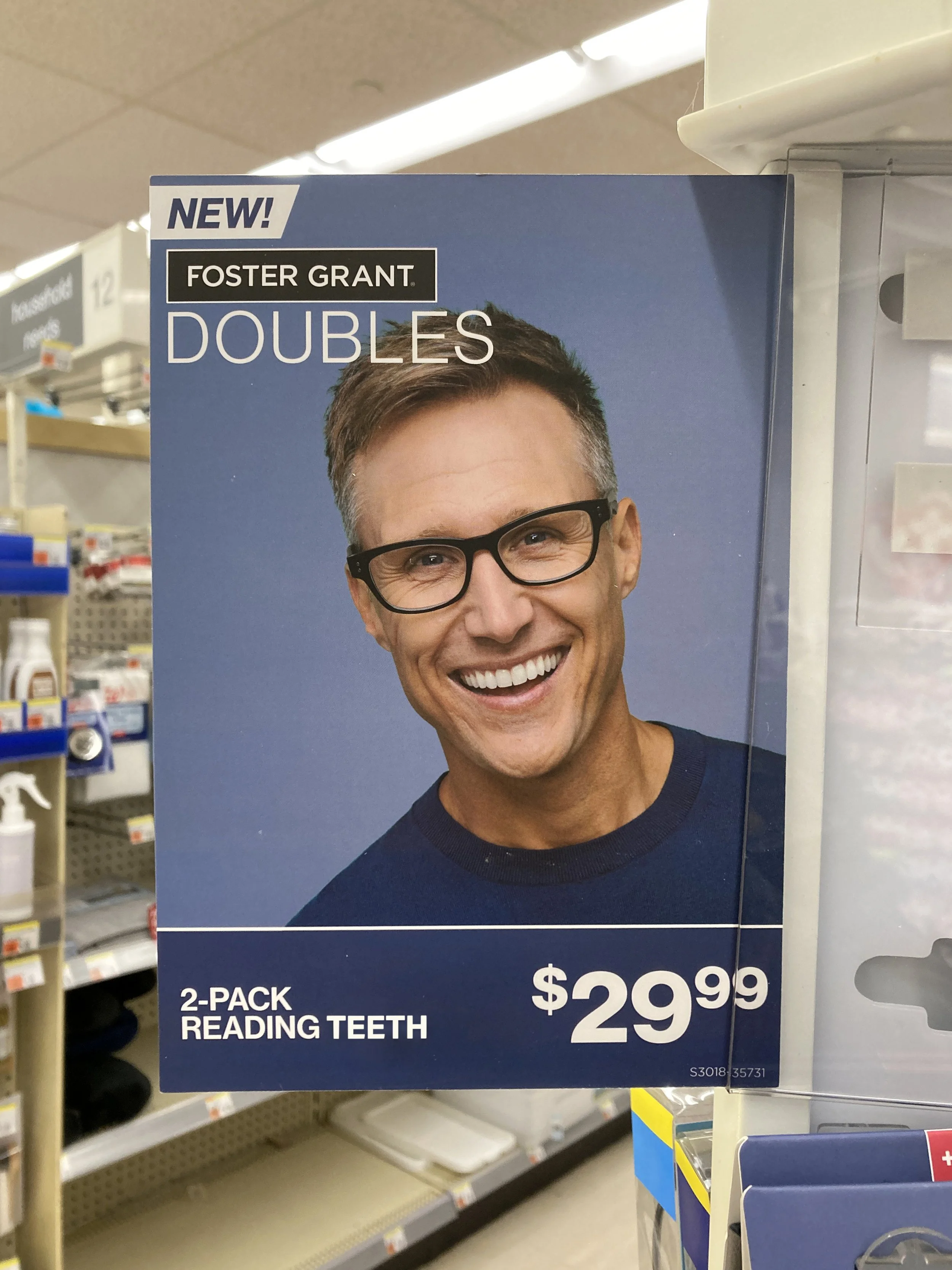 Advertisement for Foster Grant doubles reading glasses, 2-pack, priced at $29.99, featuring a smiling man with glasses.