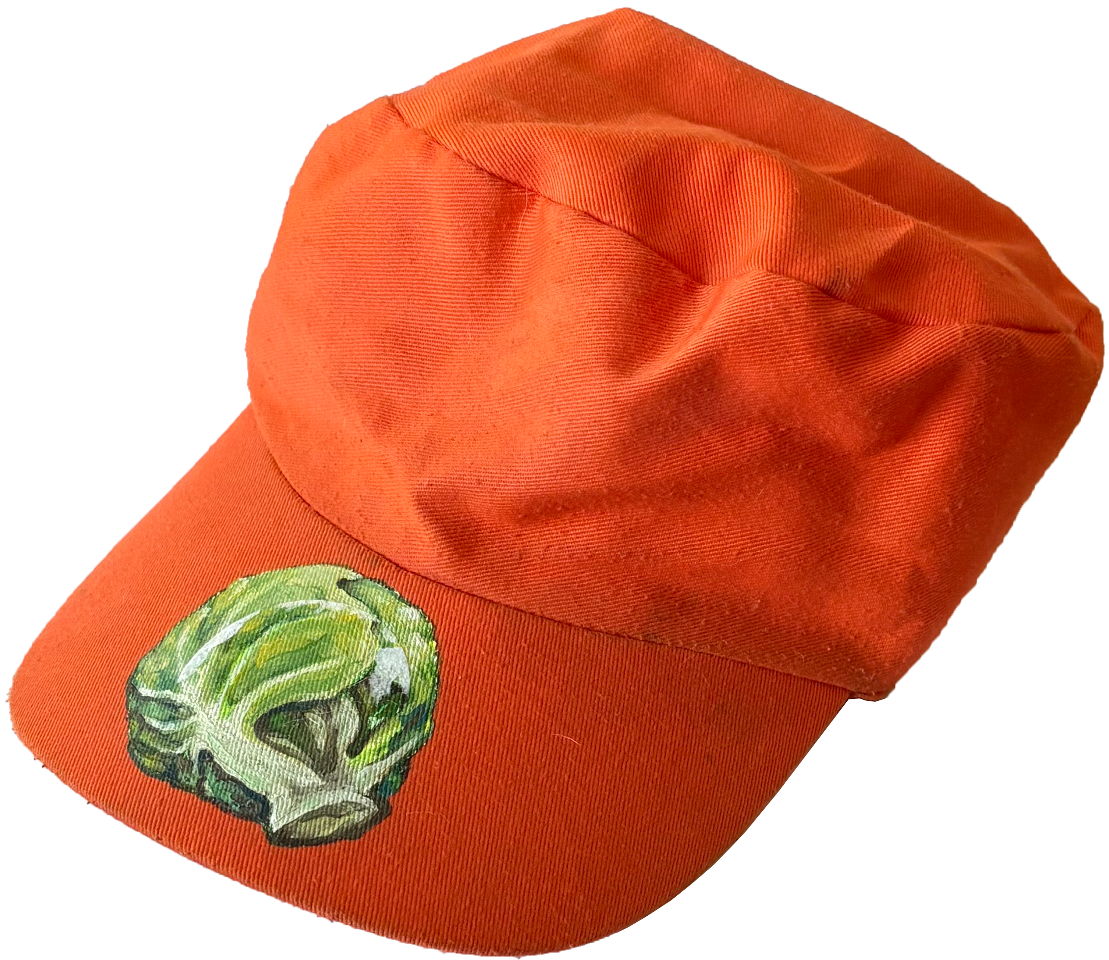 An orange baseball cap with a green skull graphic on the front.