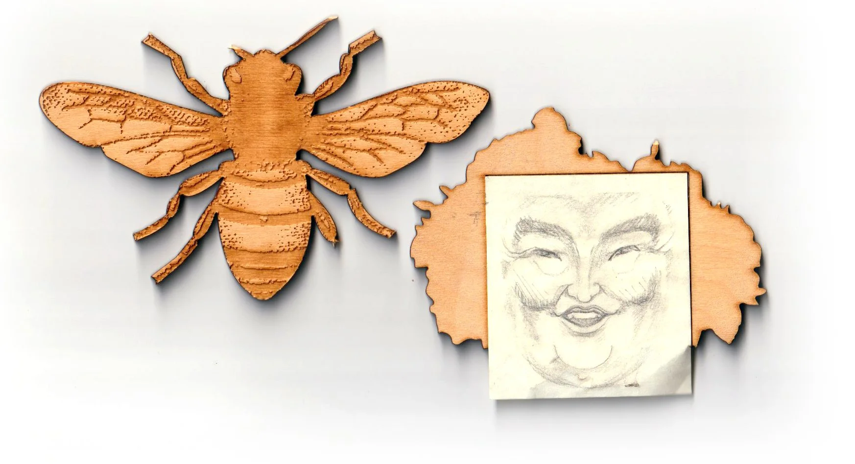 Wooden decorative piece featuring a bee and a woman's face sketch on a wooden background.