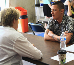 Teddy Breceda shares his story with a Reader at the Human Library. Photo by Tracie Rodriguez.