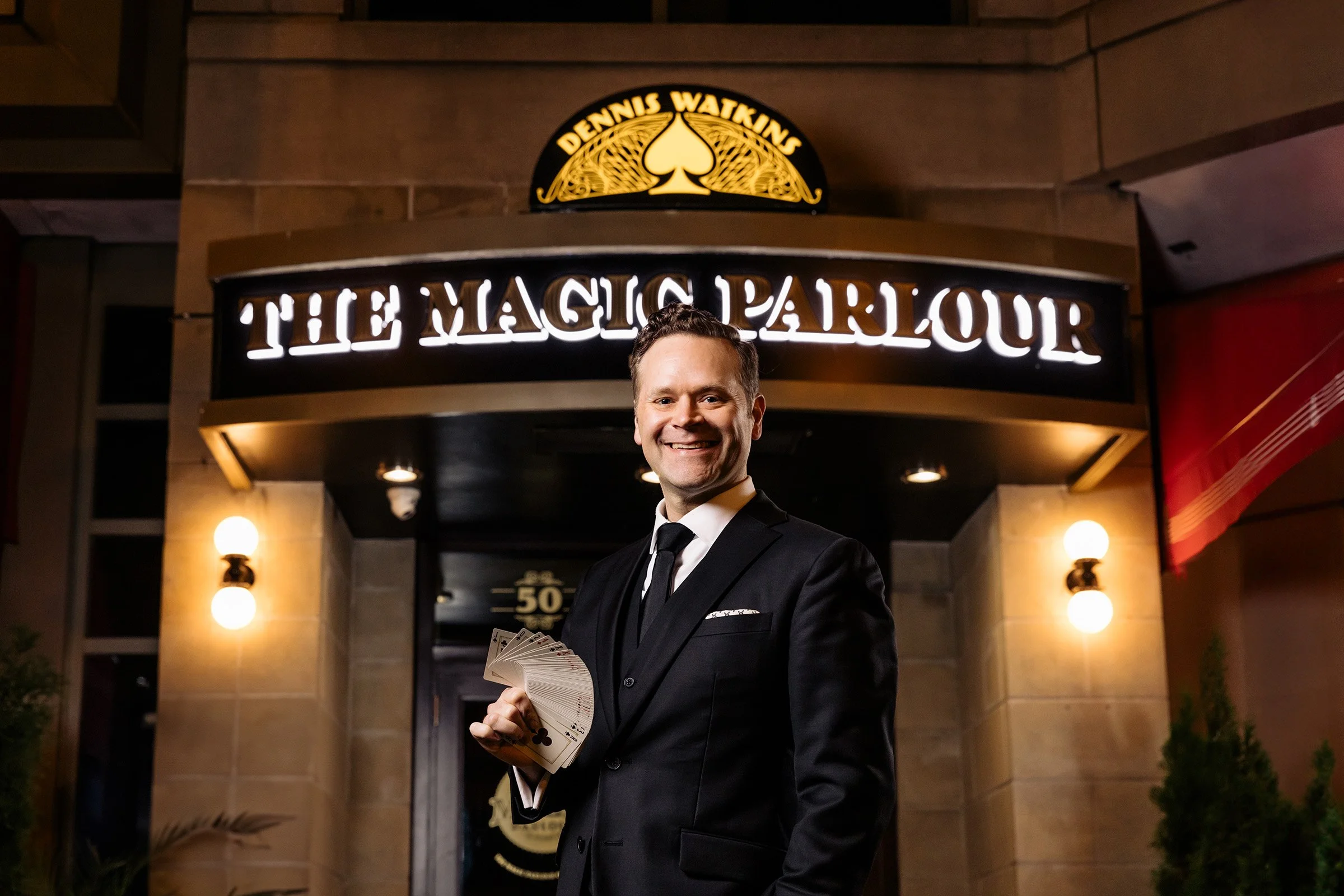 Chicago magician Dennis Watkins under The Magic Parlour marquee at 50 West Randolph