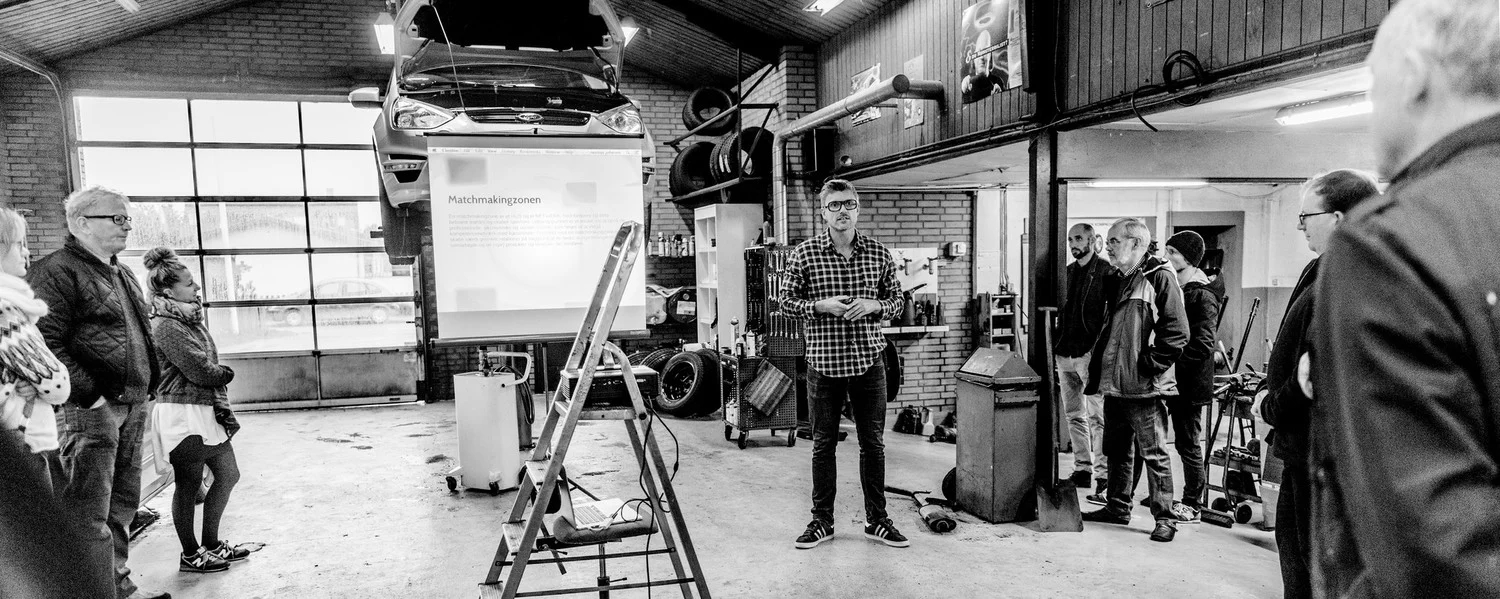 Up until the beginning of 2014, Ørhagvej 84 served as the workshop for the local car mechanic. On my left (with the gray beard) is Jørgen Beck, the mechanic, who previously ran the workshop for 35 years. The garage, we're standing in, will be turned…