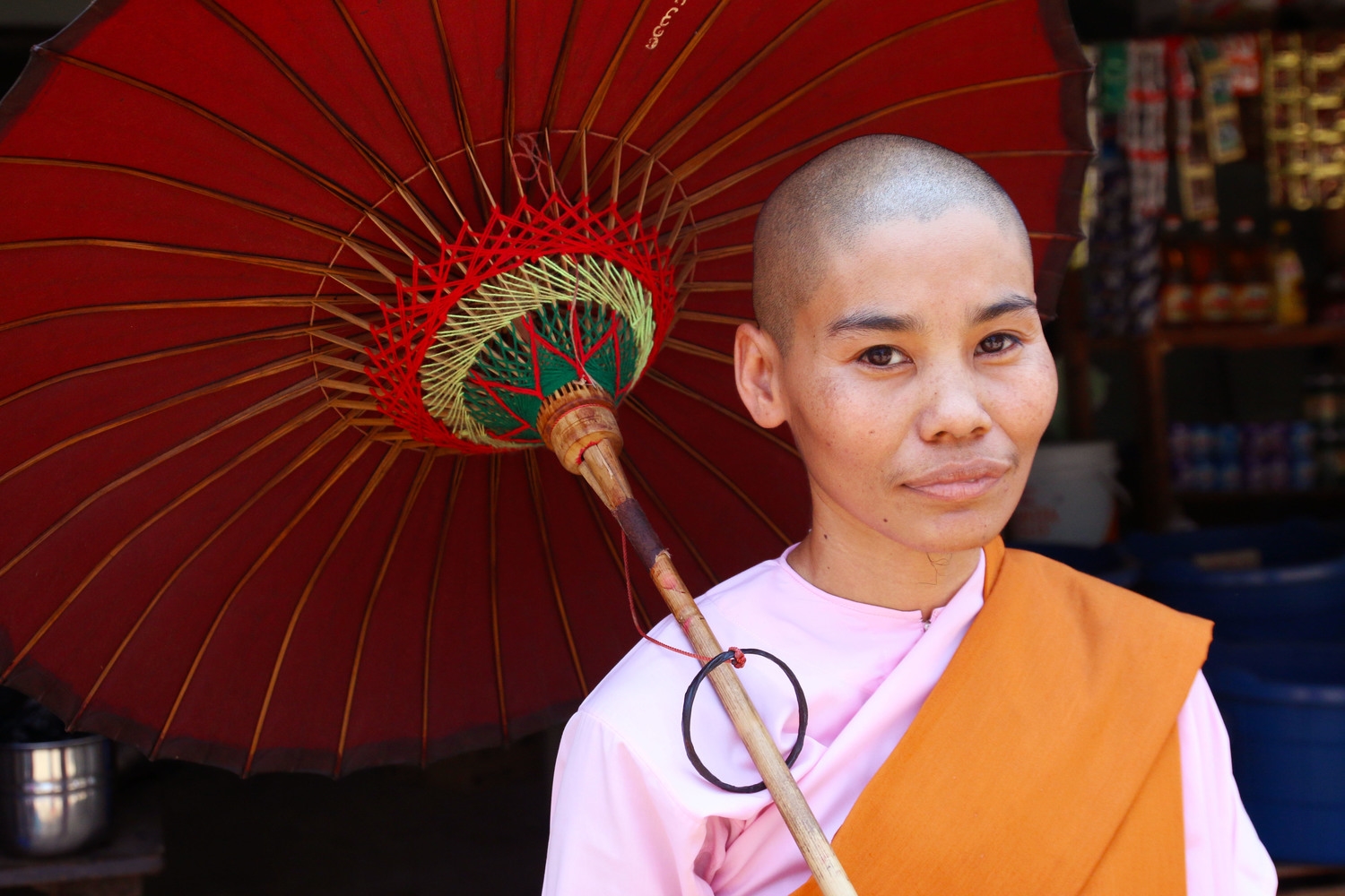 A Buddhist "lady monk" collects alms in a poor community.