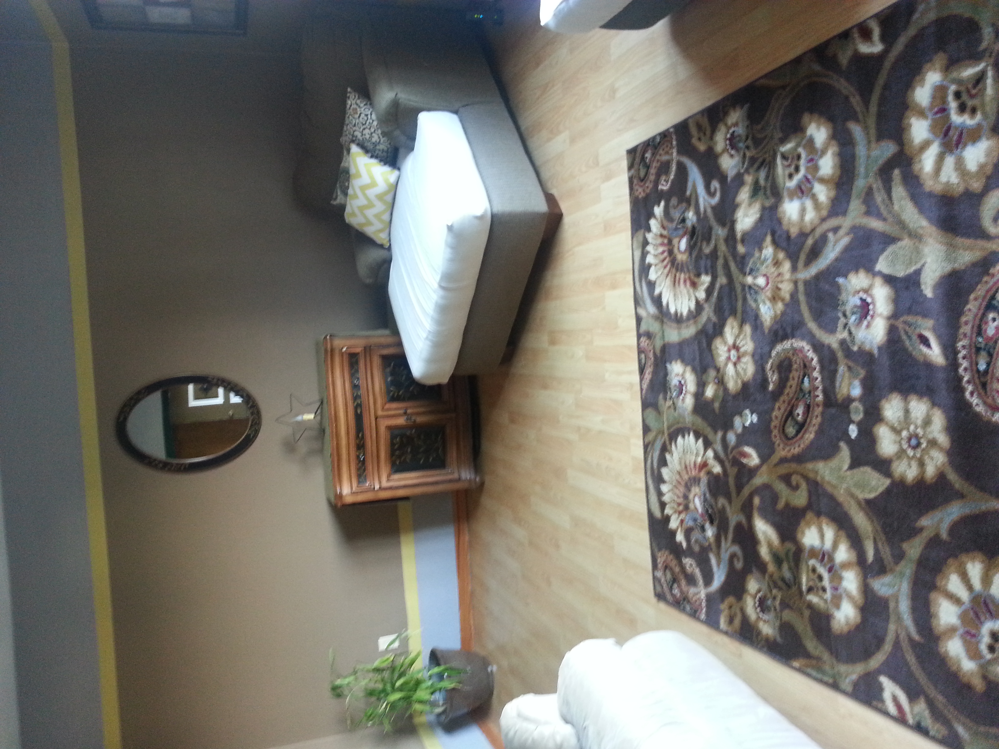 A beautiful furniture piece and mirror, previously in a corner, now takes center stage on the impression wall in the living room.