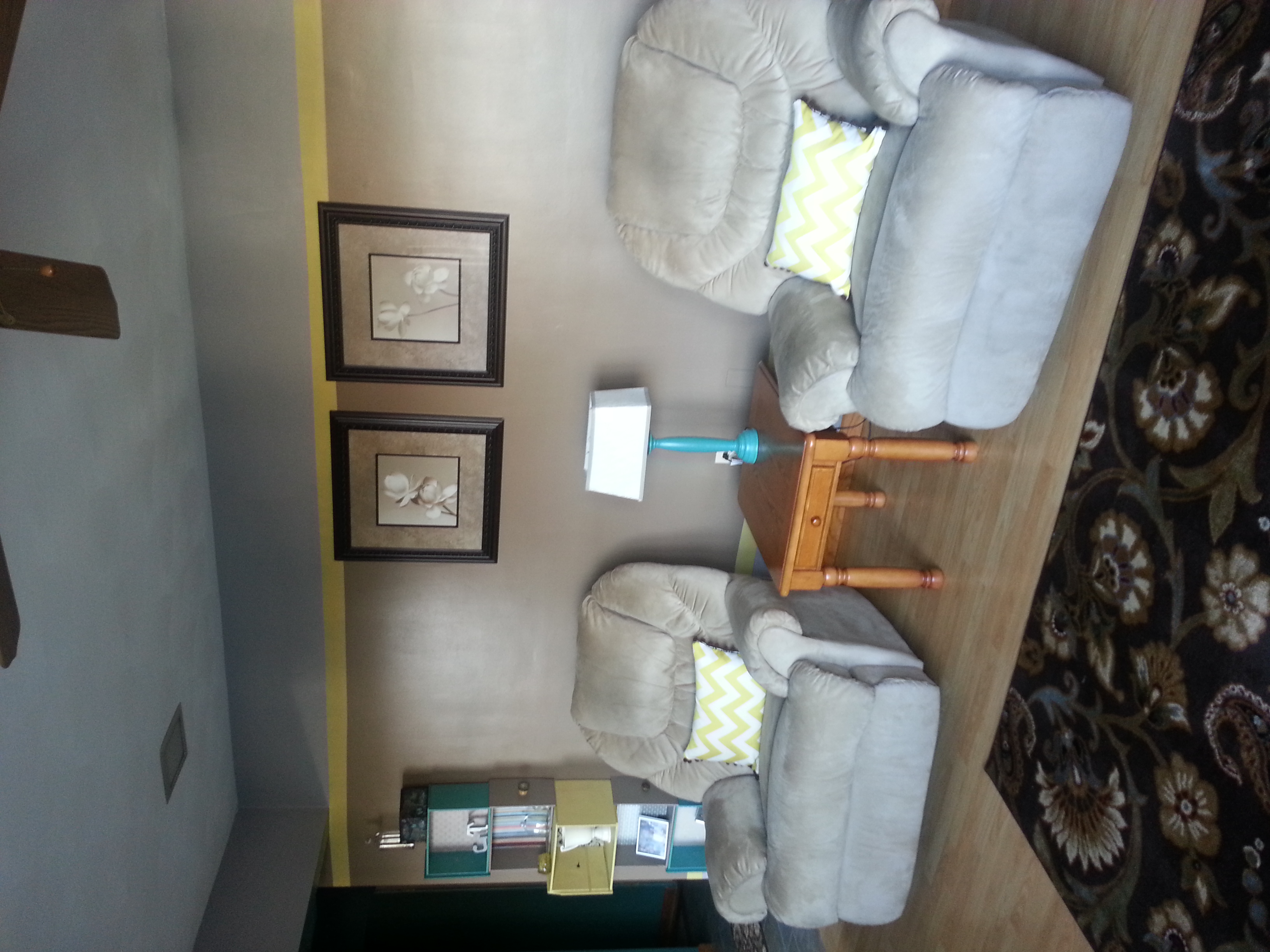 The existing furniture arrangement and pictures stay in place on this wall. A new lamp and pillows change the whole look!