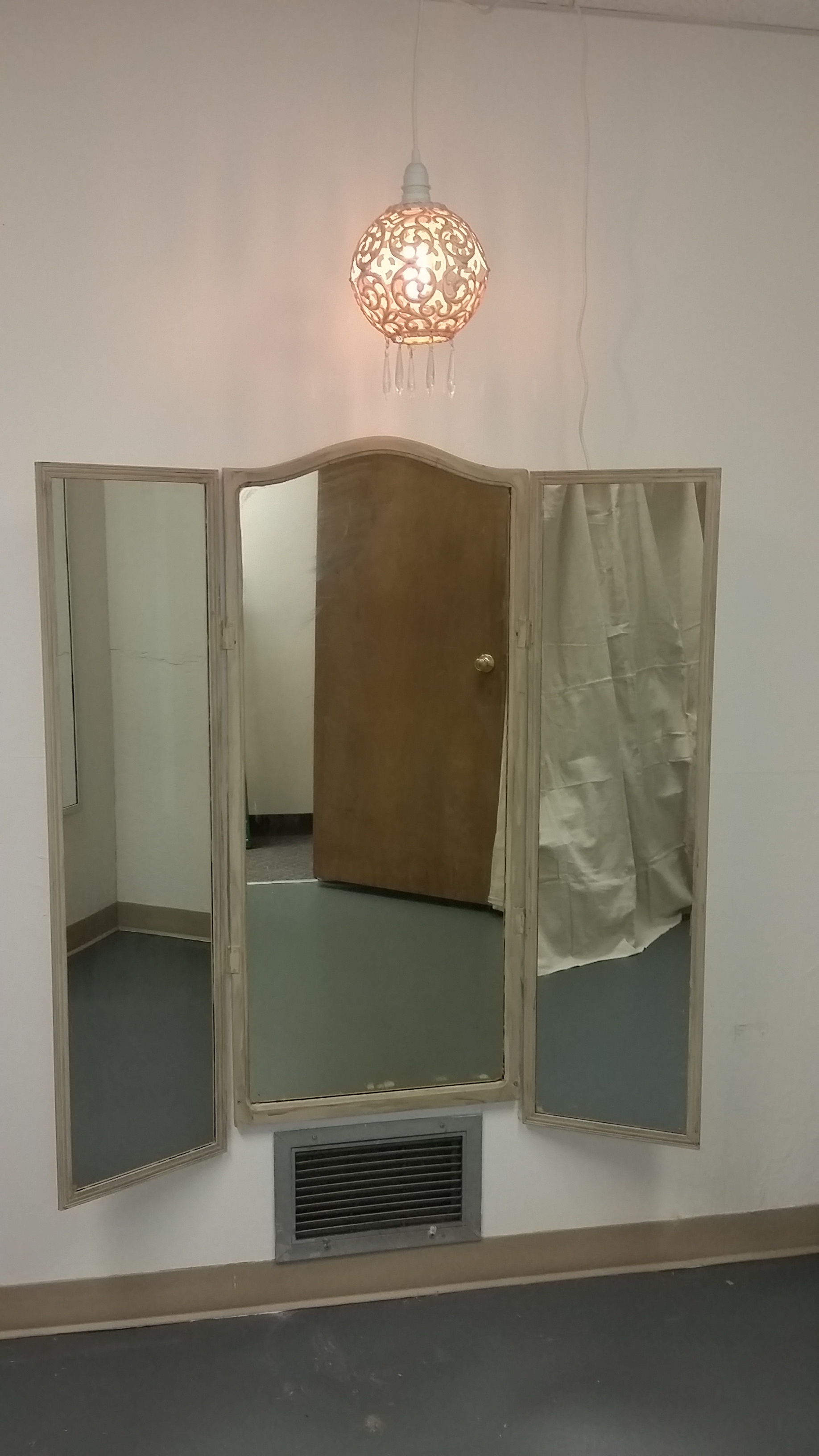 Repurposed finds combined with new mirrors, and united by paint, provide a proper three way mirror, lit by a chandelier fashioned from a vintage pole lamp fixture, Edison bulb and chandelier crystals