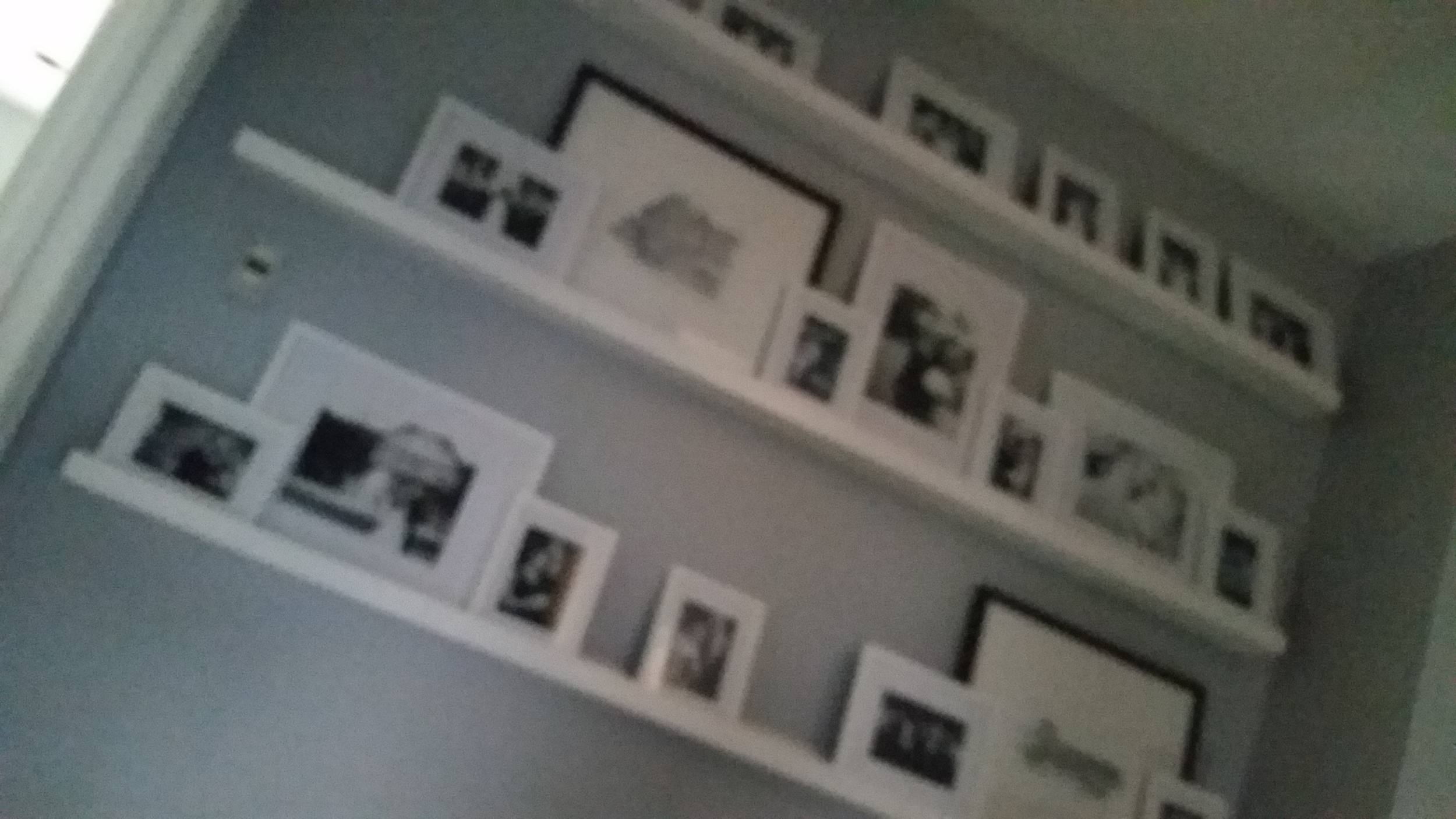 Custom made ledges were the idea of the homeowner, and provide a gallery wall for photos. They now hold black and white photos of the couple's wedding. As the family grows, the ledges can display children's artwork.