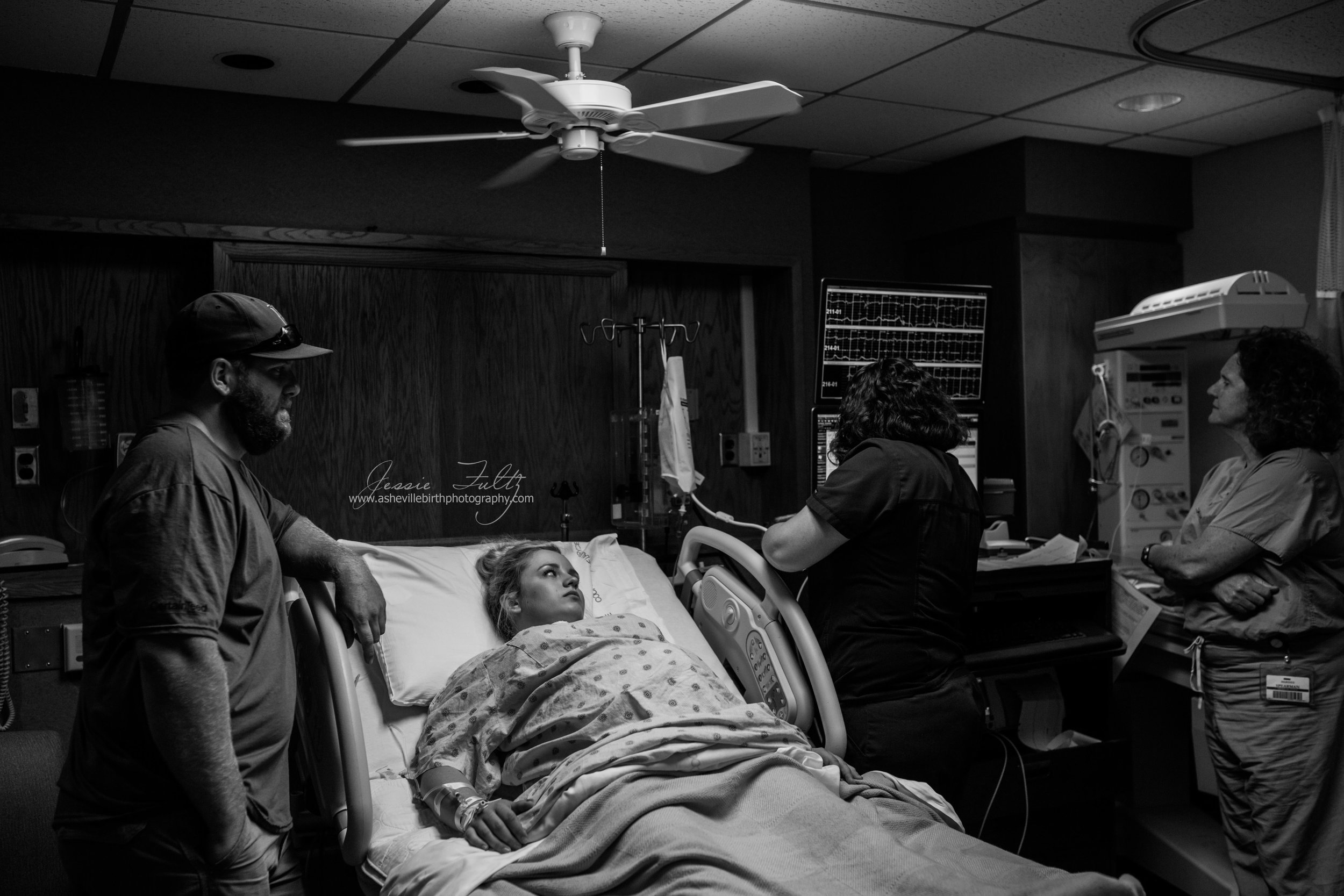 laboring woman watching as her nurse sets up her IV