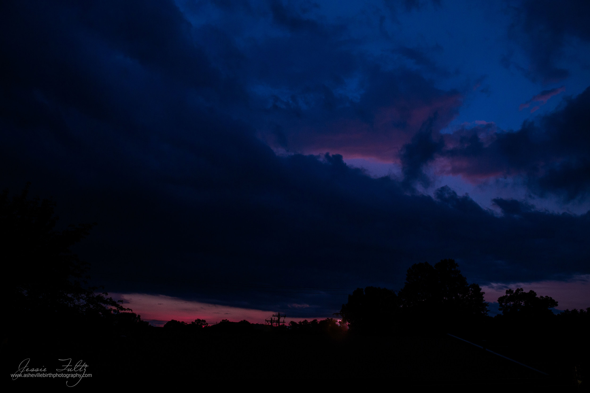 dark blue, black, and pink stormy North Carolina  sky during the end of sunset