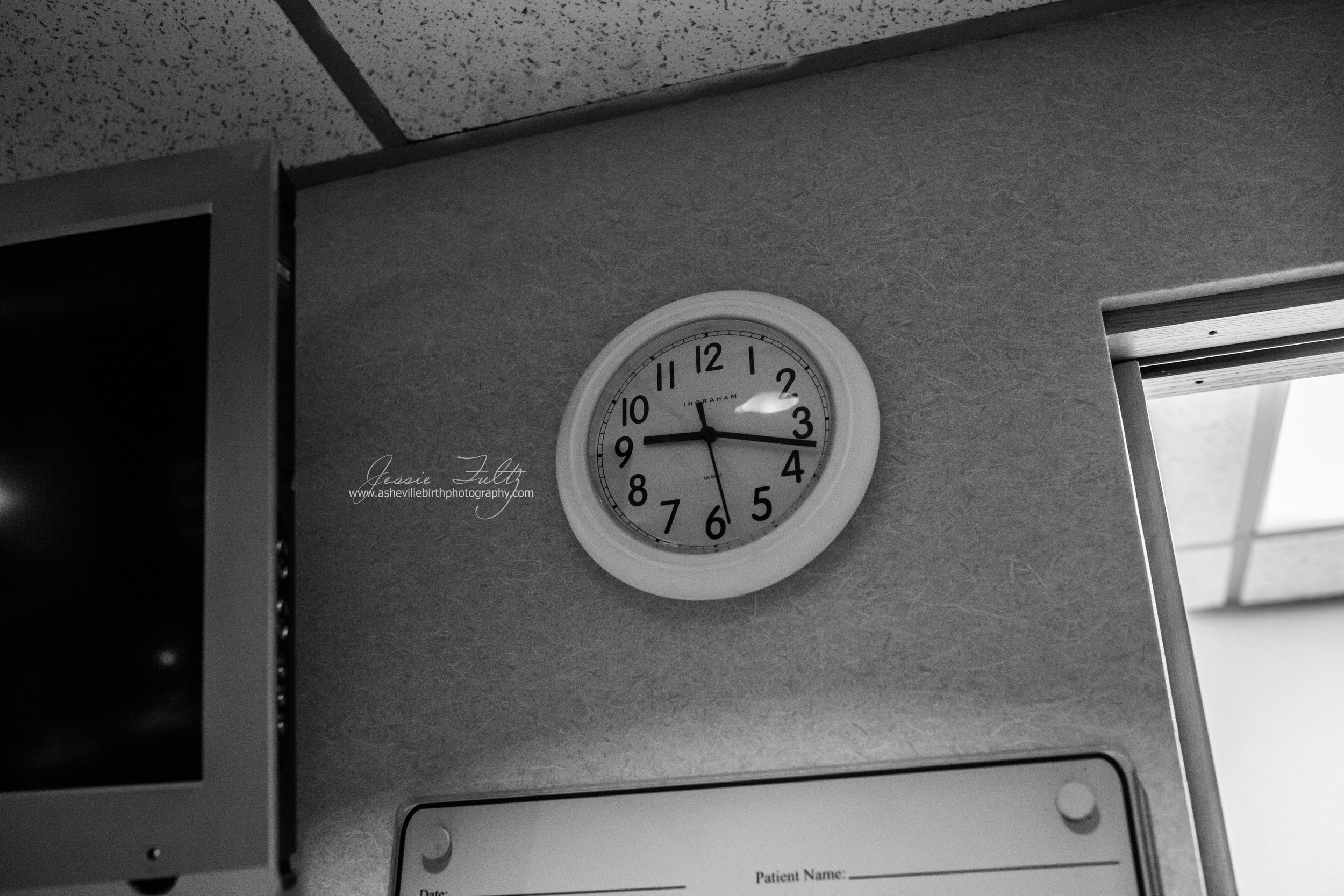 a clock reading 9:17 on a hospital wall