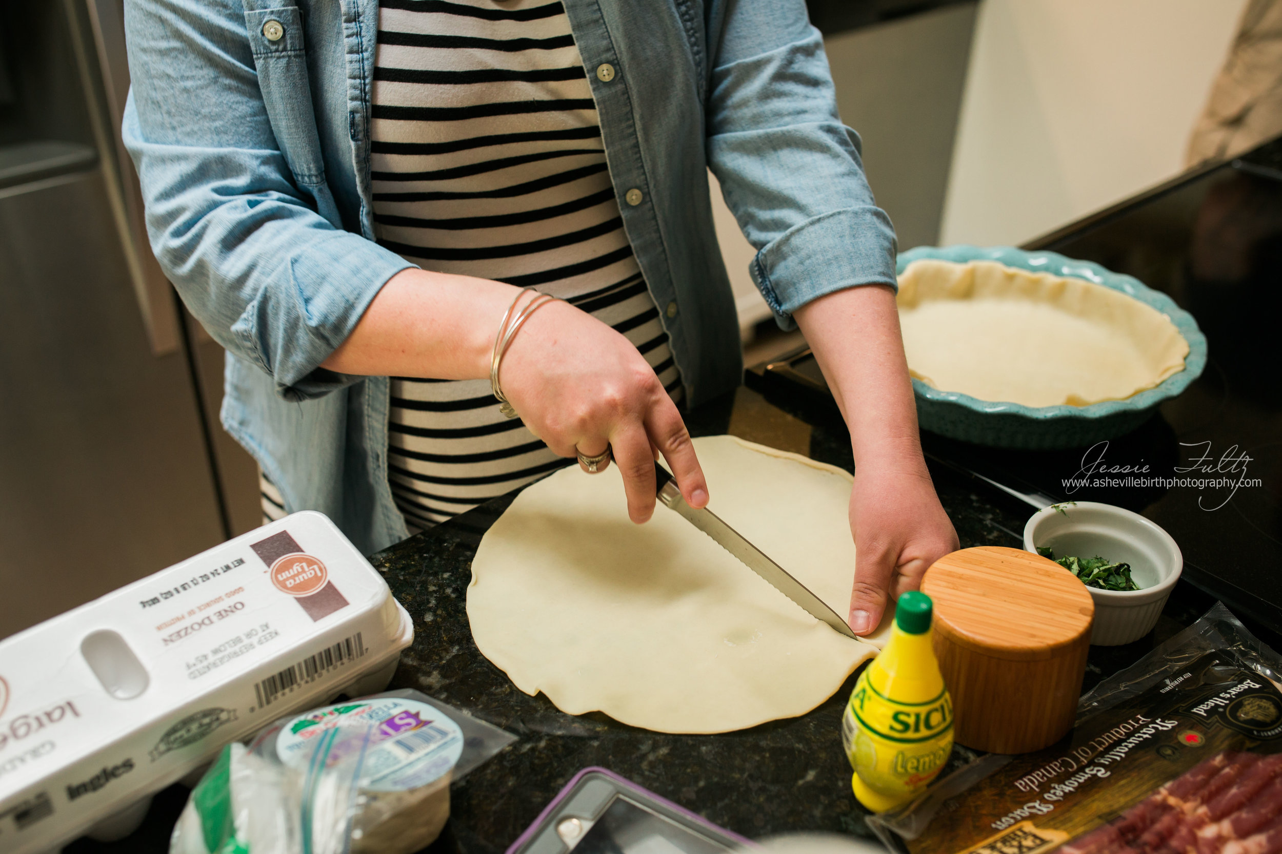 pregnant woman in striped dress cutting dough for a pie crust