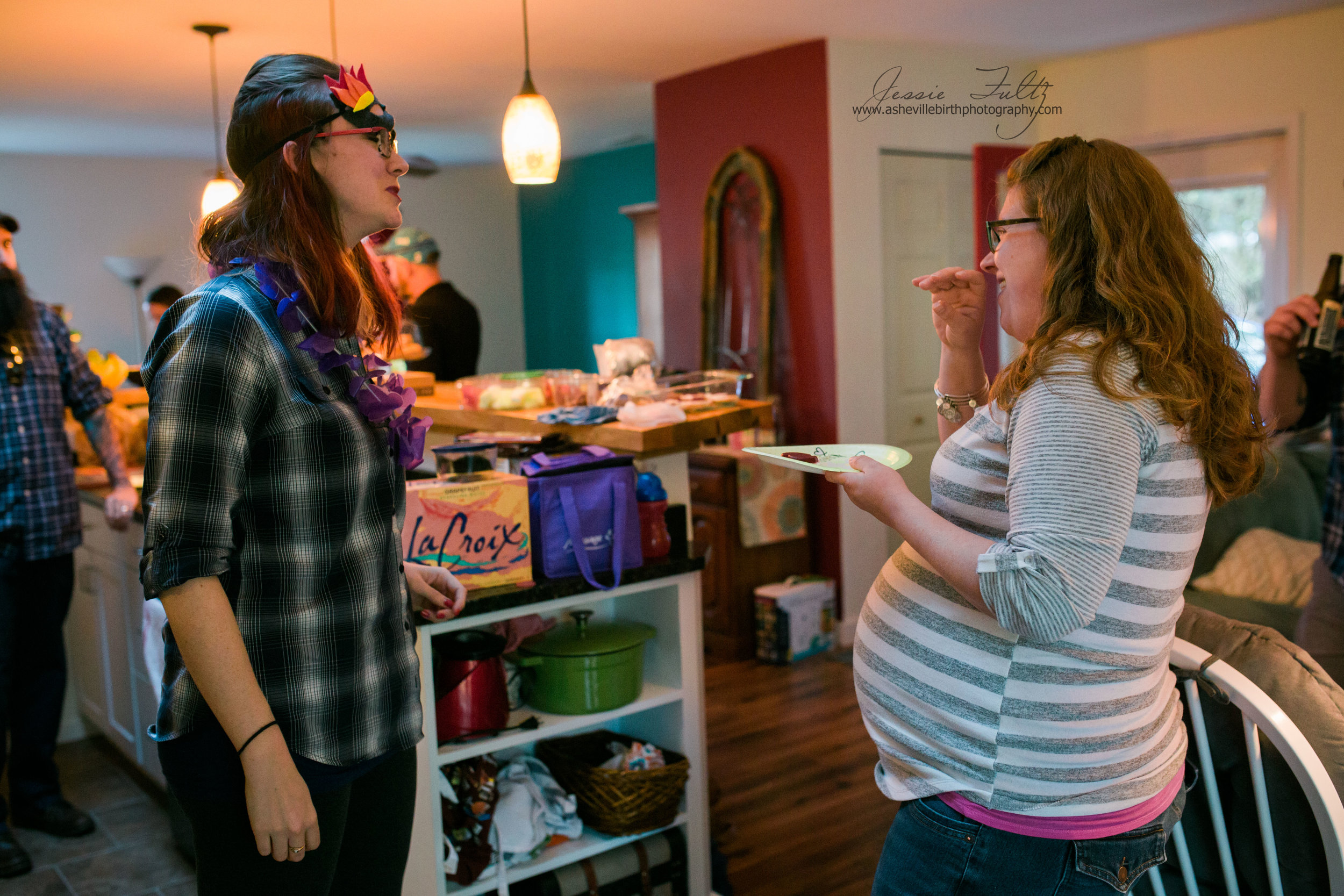 a pregnant woman and her friend laughing together