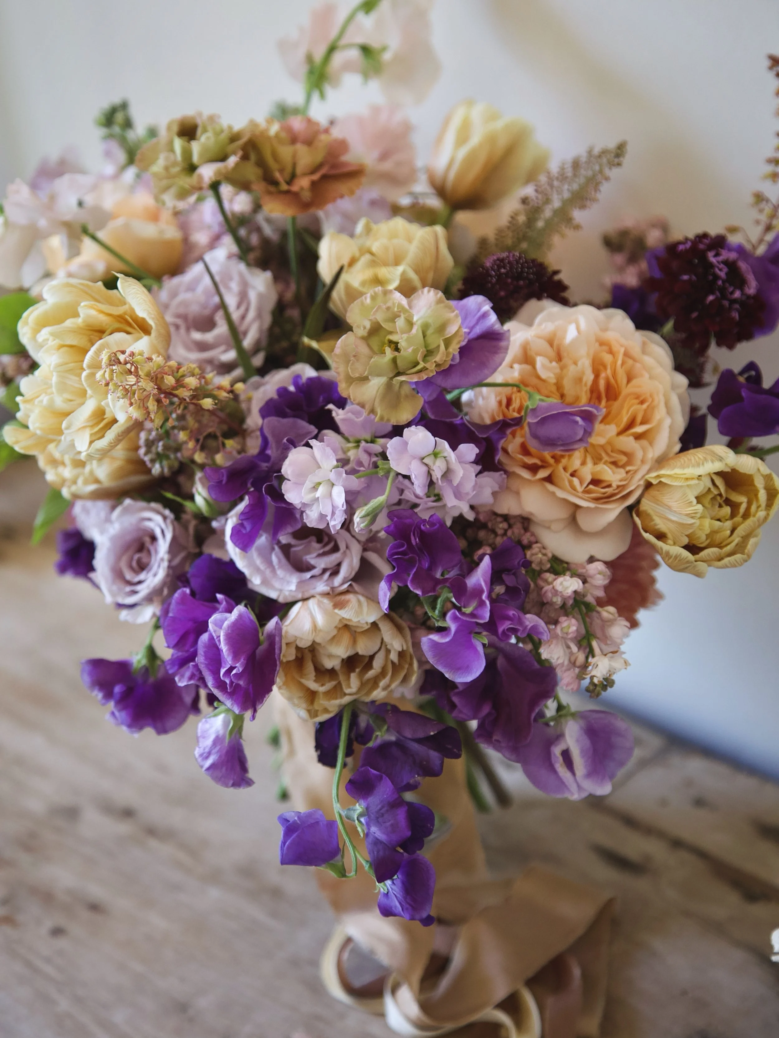 Possibly one of the only bridal bouquets in the world designed  with the coveted, retired, @david_austin_roses Tea Clipper. Hoping this rose gets brought back! Love how she pairs with these double caramel tulips.
