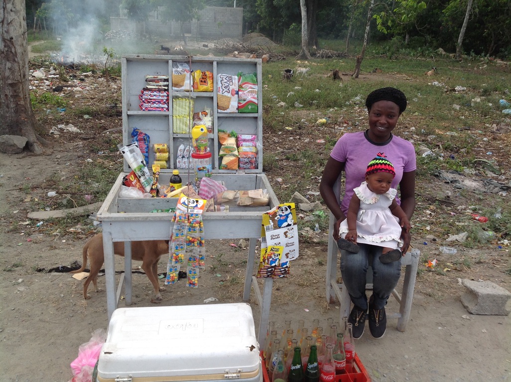 A mother who has recently graduated from Second Mile Haiti’s Malnutrition Treatment program with her now healthy daughter and successful small business