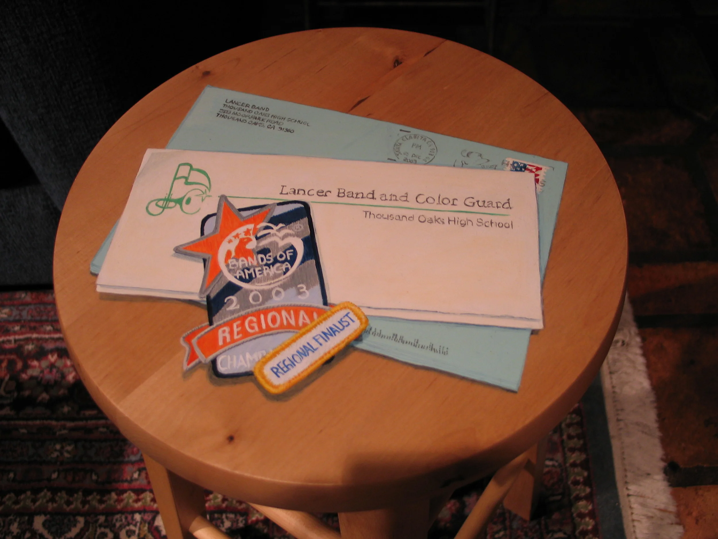 Trompe l'oile mail and patches on a stool