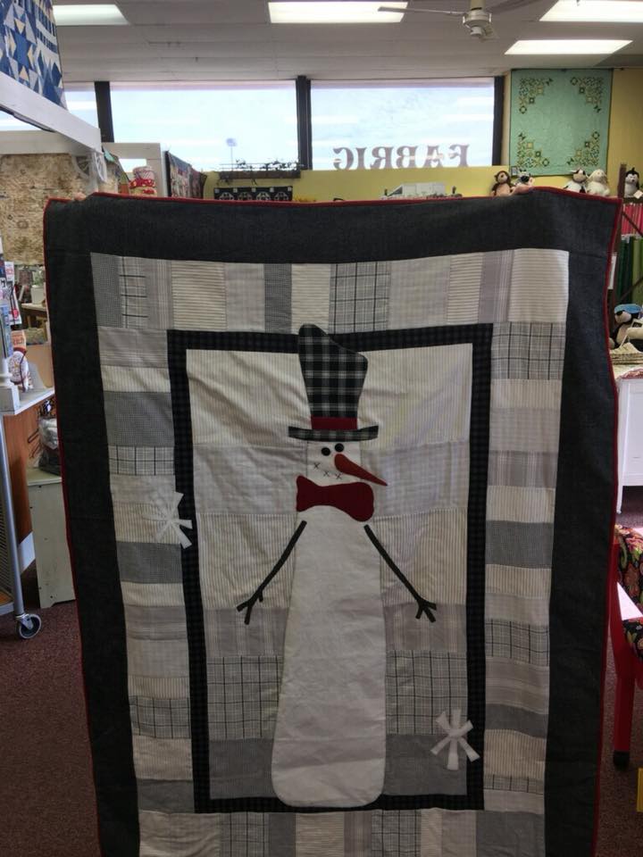 It's funny--I helped put together the kits for this quilt recently and when a customer came in with a finished quilt, I felt so proud! (As if I'd had anything to do with it besides pick out some fabric. <grin>)