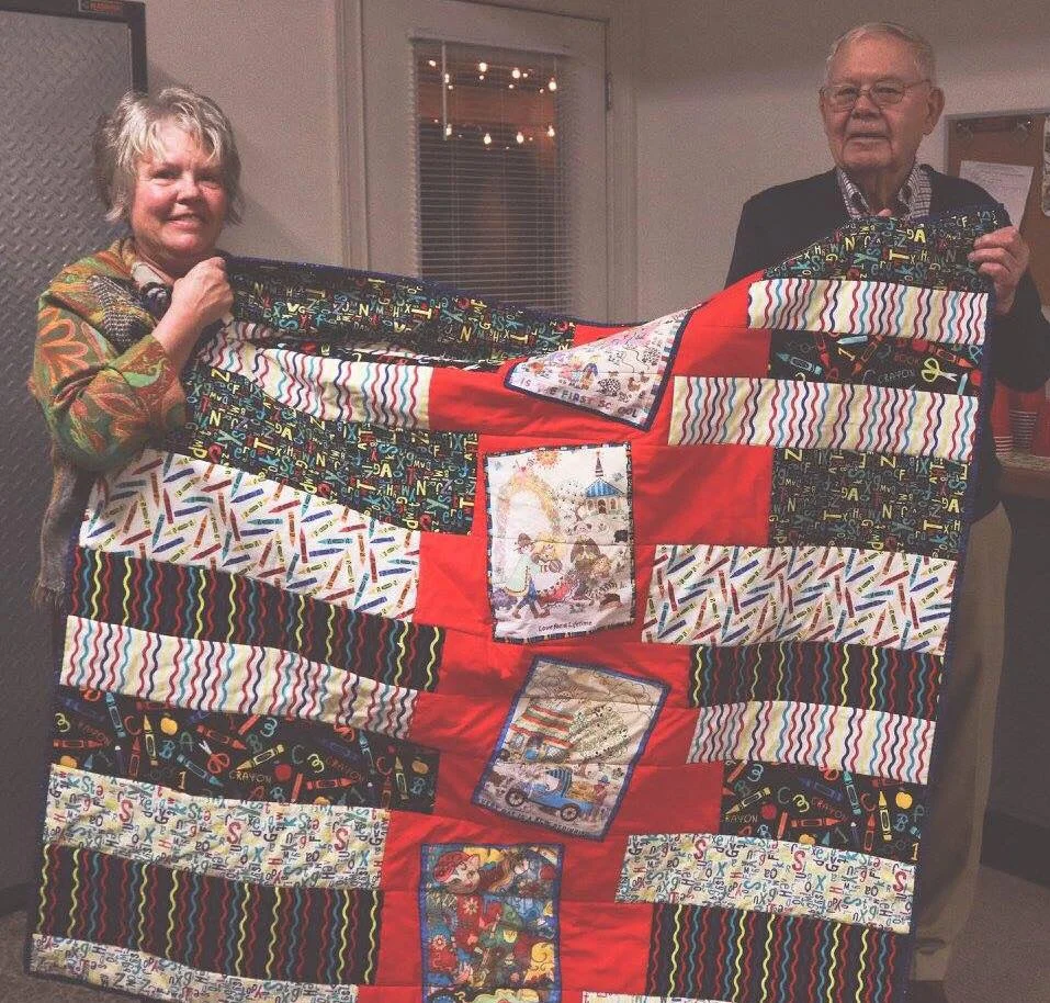 This customer, Gene Murdock, brought in this quilt made with drawings her Dad colored and she copied onto fabric. What an awesome idea!