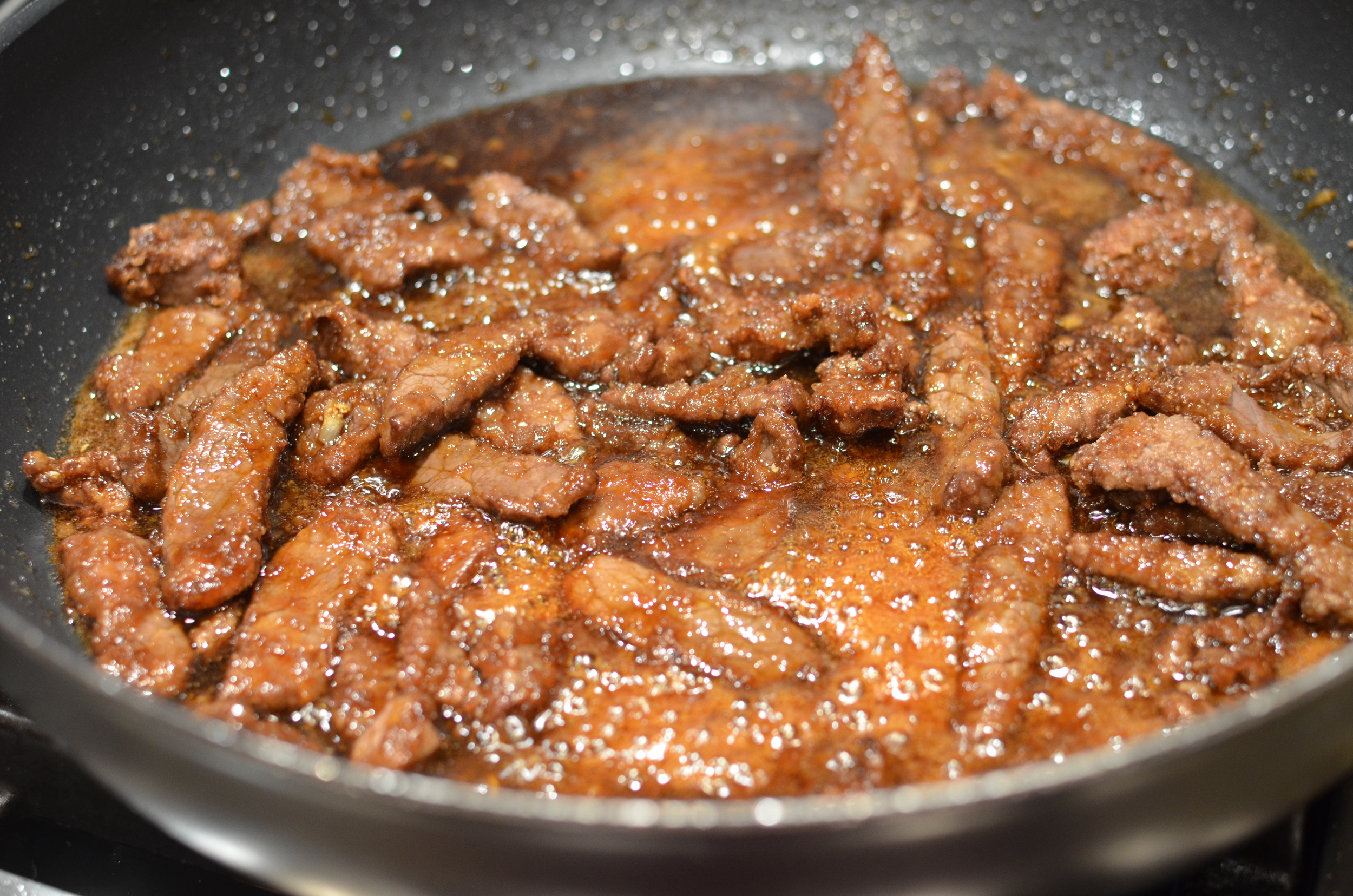 Return sauce to heat; add steak strips and stir for several minutes until cooked through.