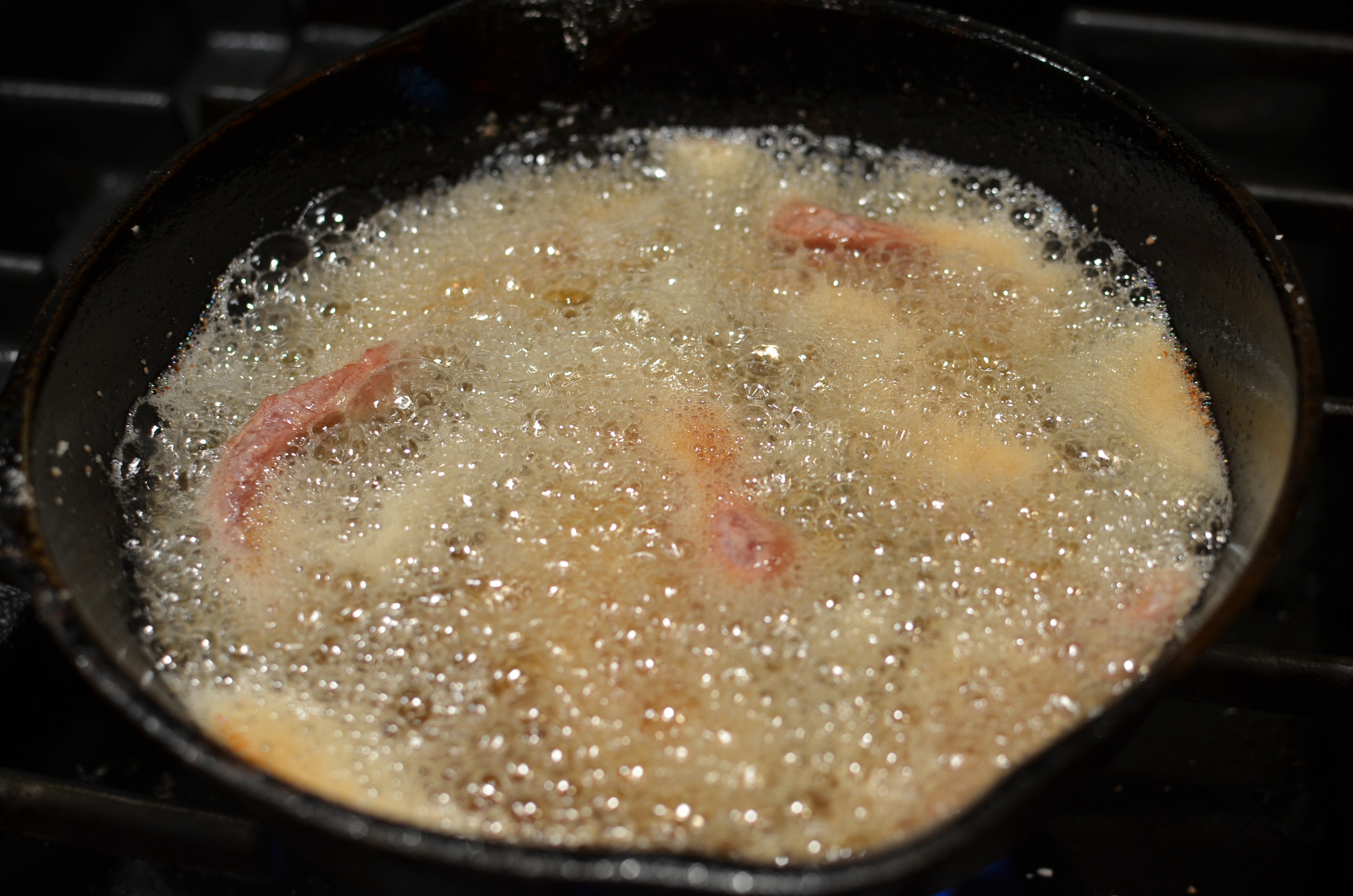 Fry the steak strips in batches until the edges turn brown.