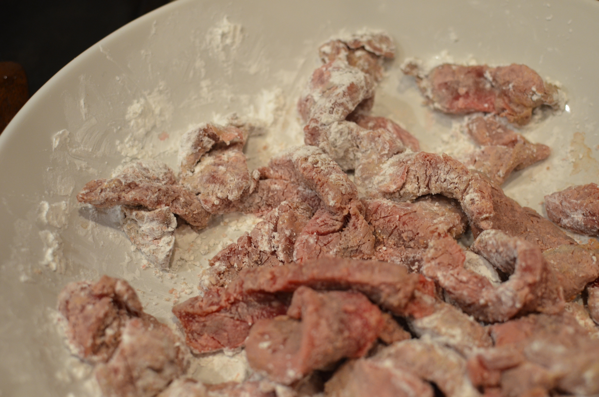 Toss the steak strips with cornstarch and let them rest until the oil heats up.