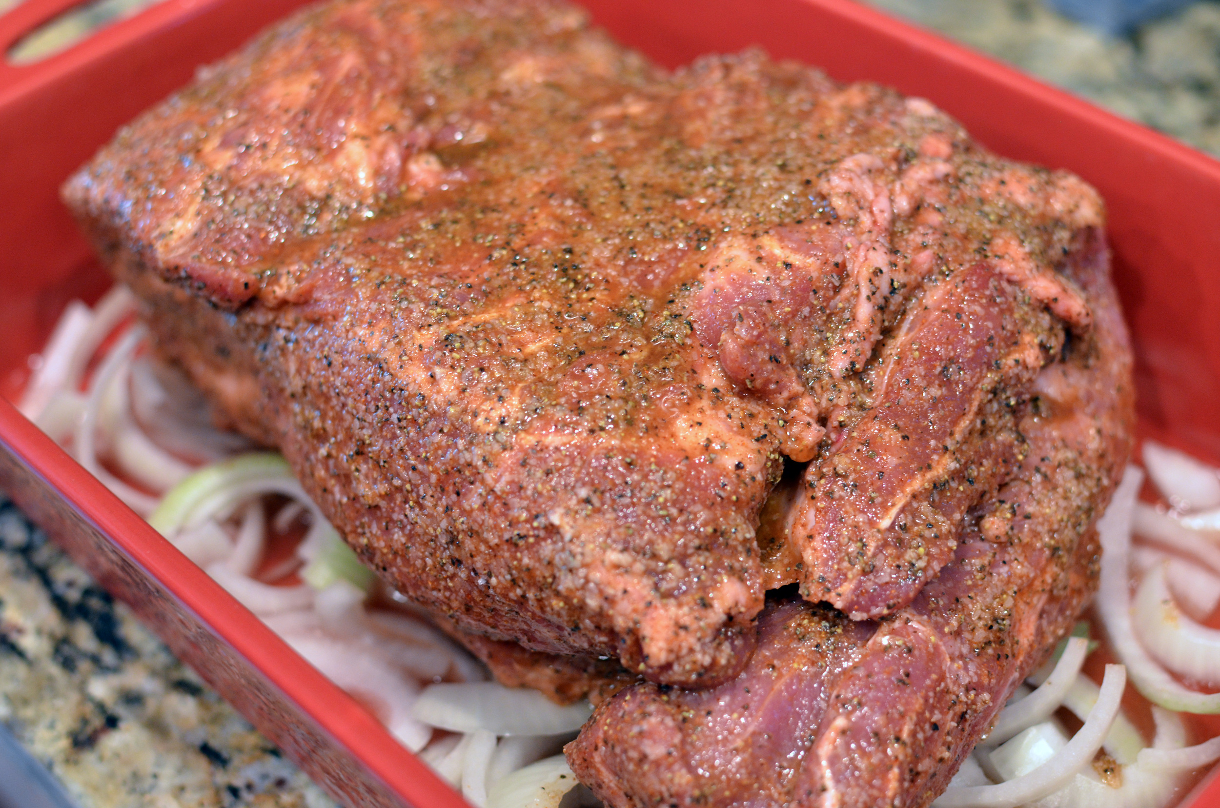 Rub the seasoned salt, kosher salt, garlic powder, black pepper, and liquid smoke all over a 5-pound pork butt (shoulder); cover pan well with foil and pop in a 350F oven for 2 1/2 to 3 hours or until the internal temperature reaches 170F.