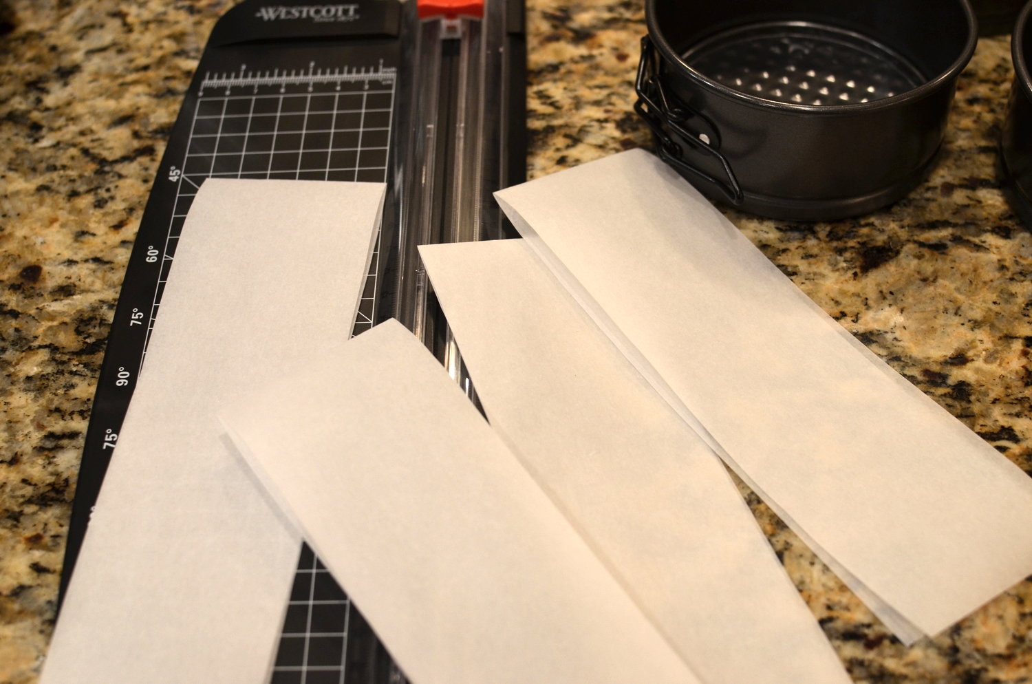Rulers, calculators, paper cutters - just a few of the office supplies that have made appearances in my kitchen since joining Rose's Alpha Bakers. Okay, let's start by preparing 4x1.75-inch diameter springform pans. C ut parchment paper into 13x2.25 inch strips. 