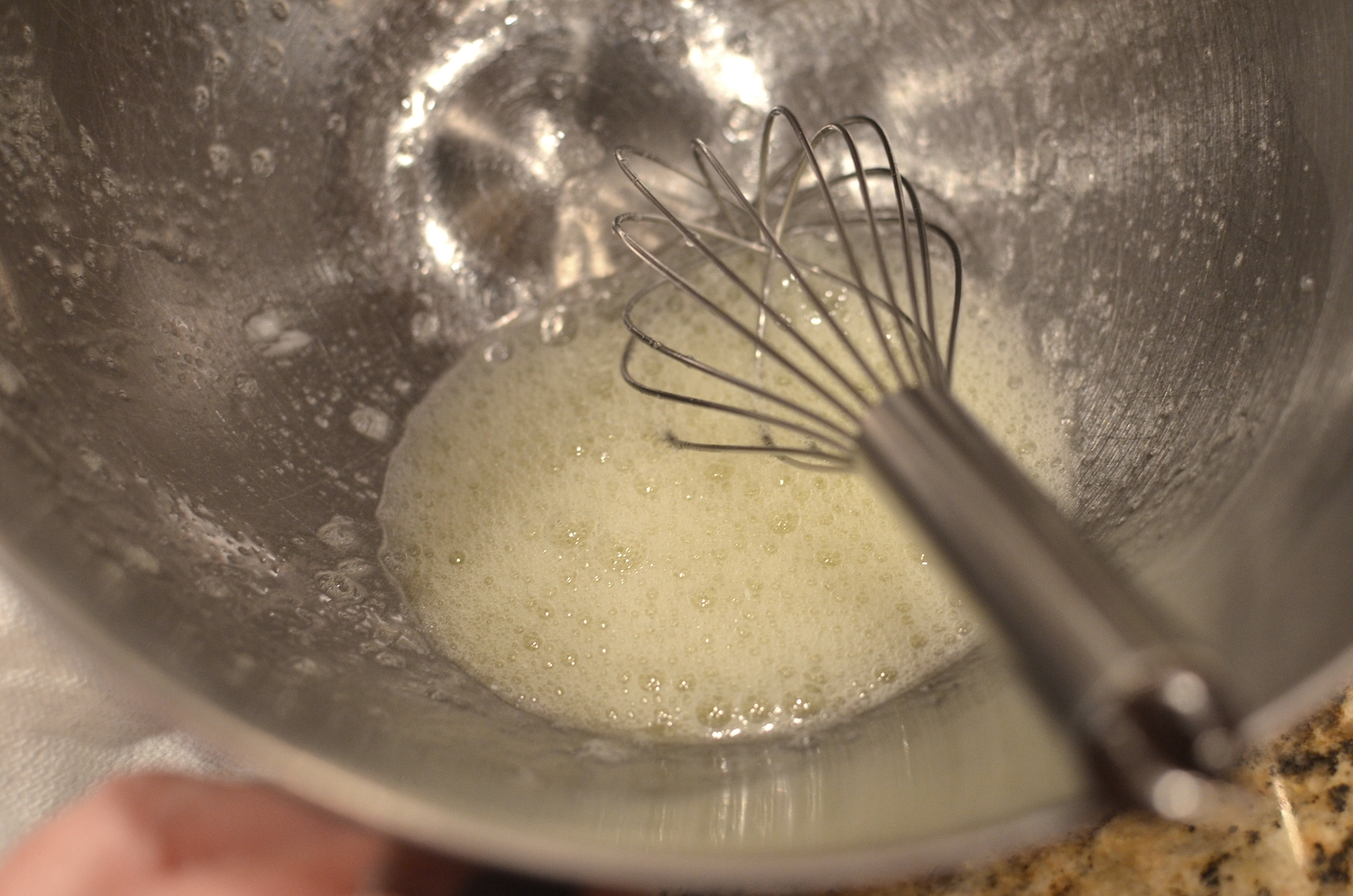 Use a hand held whisk to froth the egg whites a bit before letting the stand mixer take over.