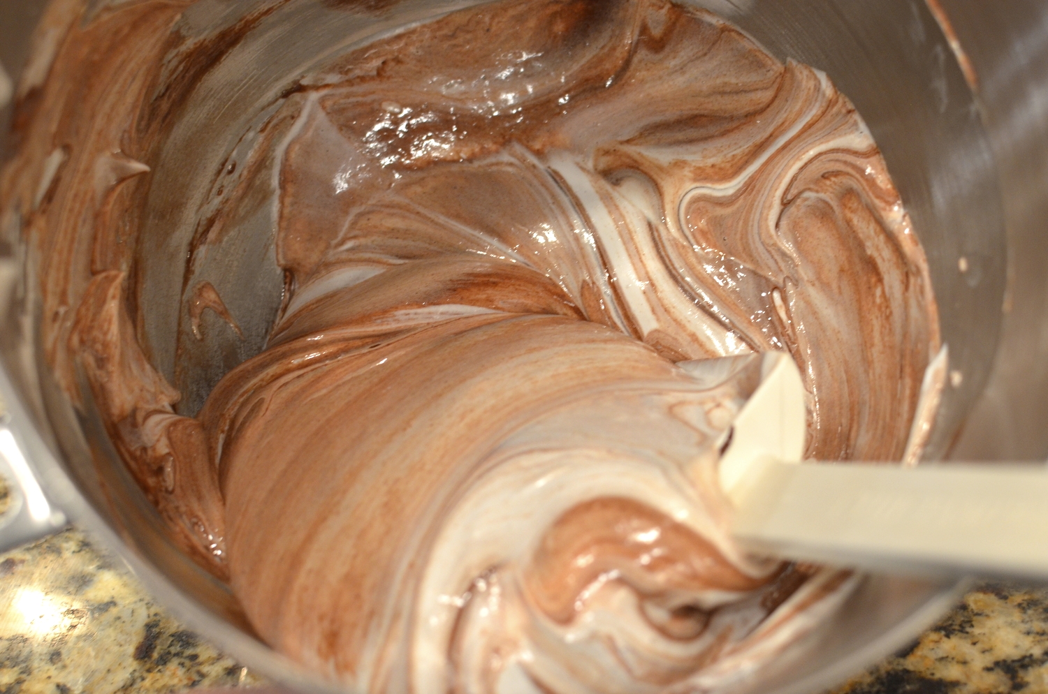 Gently fold the chocolate cake batter together with the whipped egg whites.