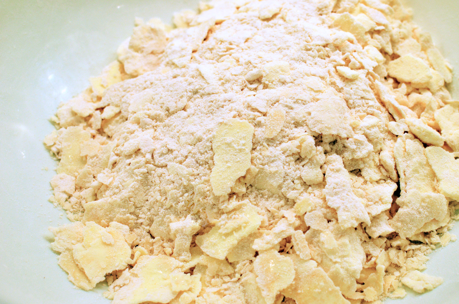 Here's what the mixture looked like when I emptied the bag. Some of the butter flakes were huge - not sure how they were supposed to get incorporated into the crust, but the directions simply said to stir in the cream and vinegar into the frozen butter and flour. I didn't see that ending very well so I pulled out my trusty pastry blender again. 