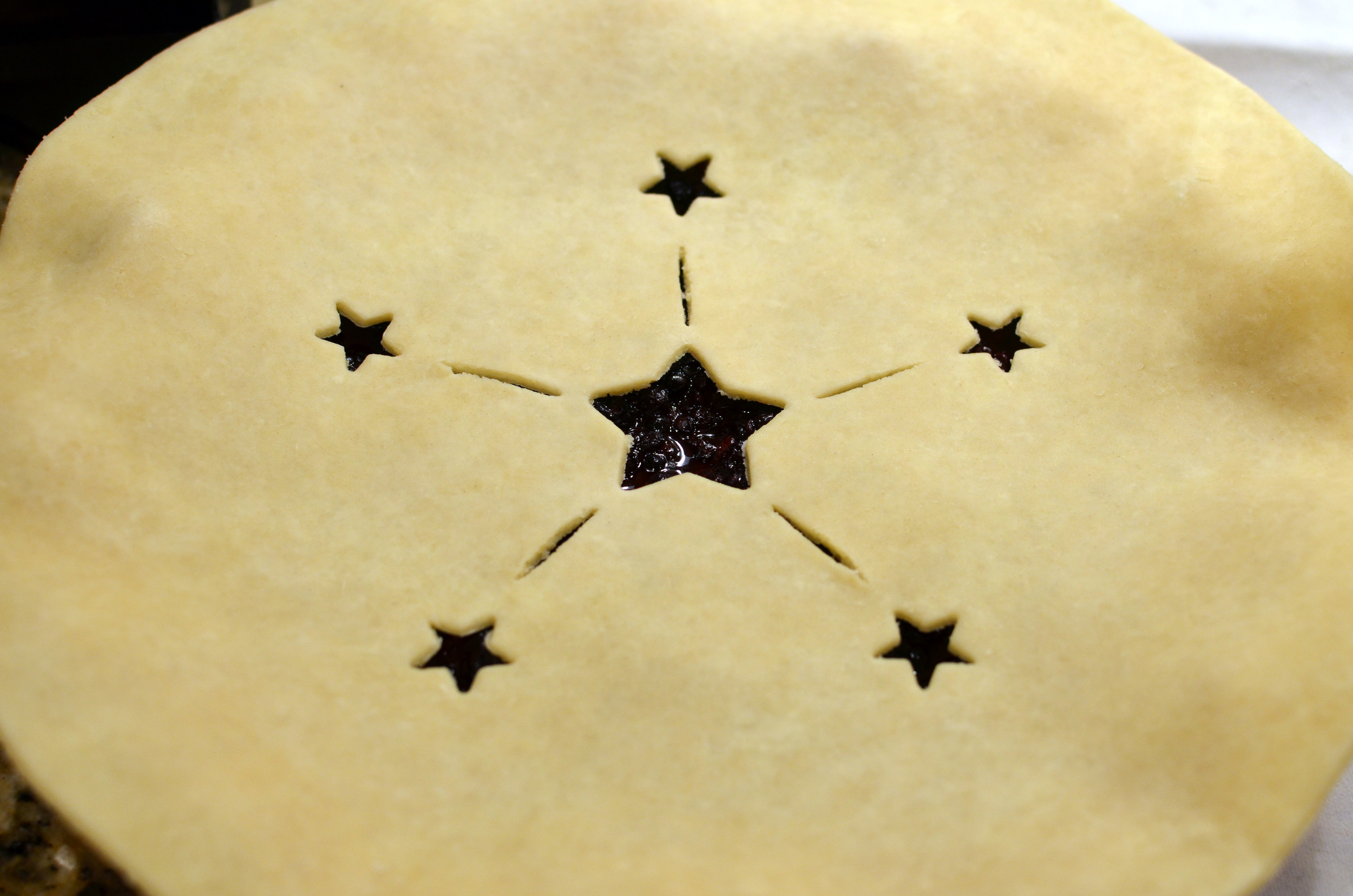 The top crust is rolled and cut into a 12-inch circle, just like the bottom crust. I added a star motif, but you should check out some of the other designs by my fellow Alpha Bakers.