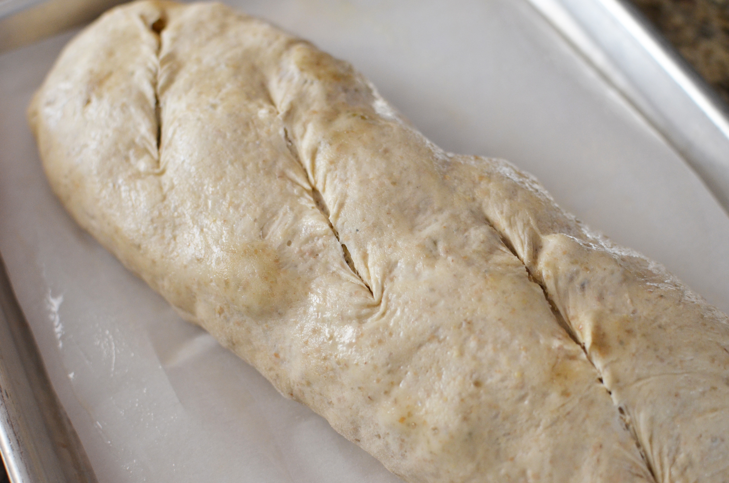 Okay, so I need to hone my dough slashing skills. The top slash doesn't quite have the right angle. Grr. Okay, I'm over it. Time to mist the loaf with water.
