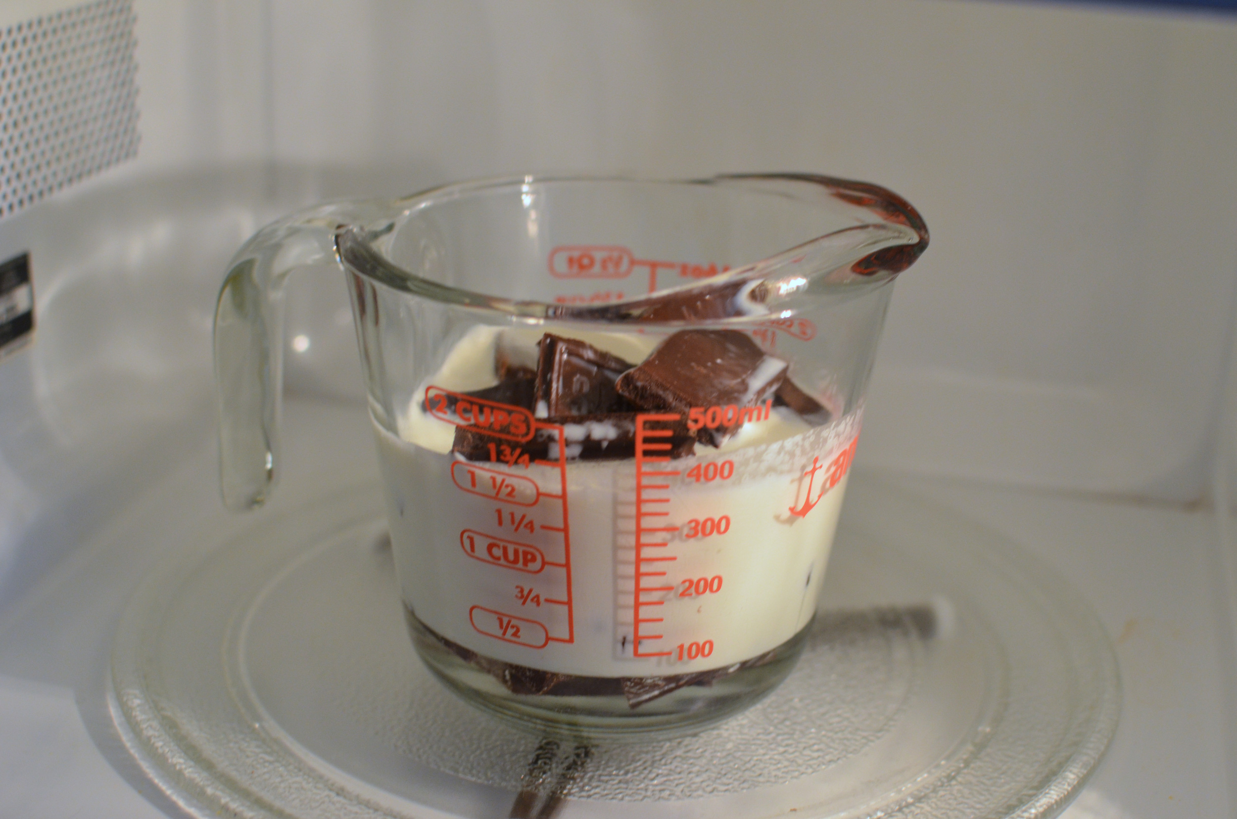 Instead of following the written instructions for making the ganache which include dirtying a measuring cup, a saucepan, and a food processor, I just put all the ingredients into a measuring cup and melted them together in the microwave. 