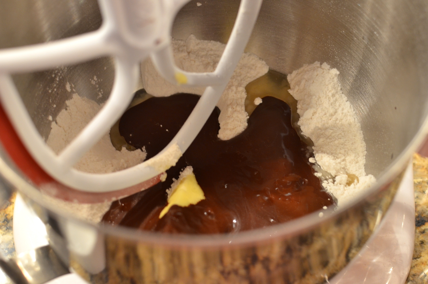 Add room temperature butter, oil, and the reserved cocoa mixture we made earlier.