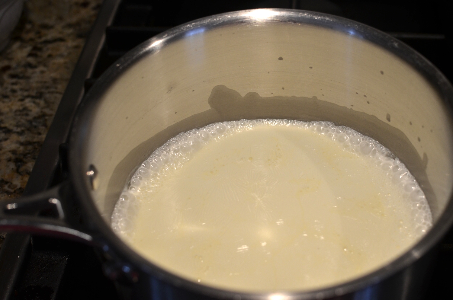 In a separate heavy-bottomed pan , scald the heavy cream. Scalding is bringing the cream up to the point where it's just about to start boiling. When you see bubbles form around the perimeter of the pan, turn off the heat. 