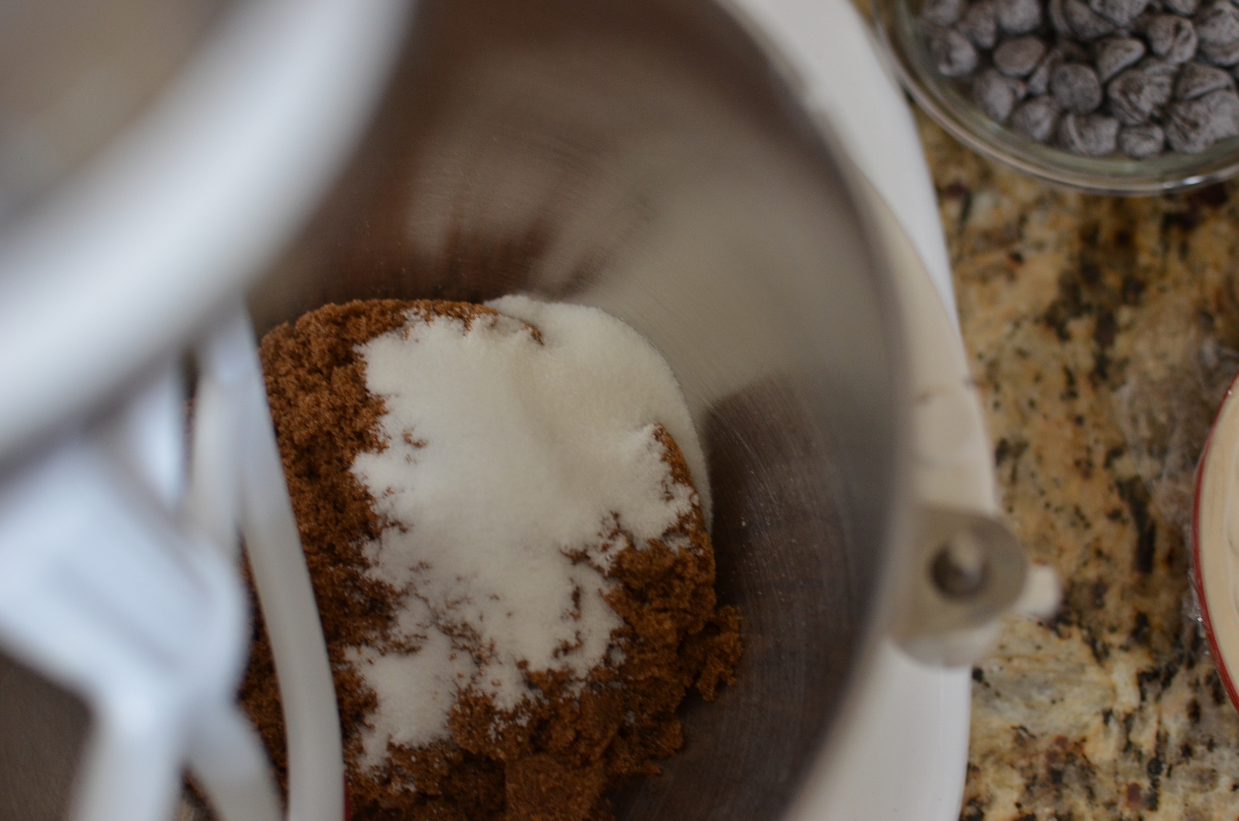 In the bowl of a stand mixer fitted with a flat beater, combine the sugars.