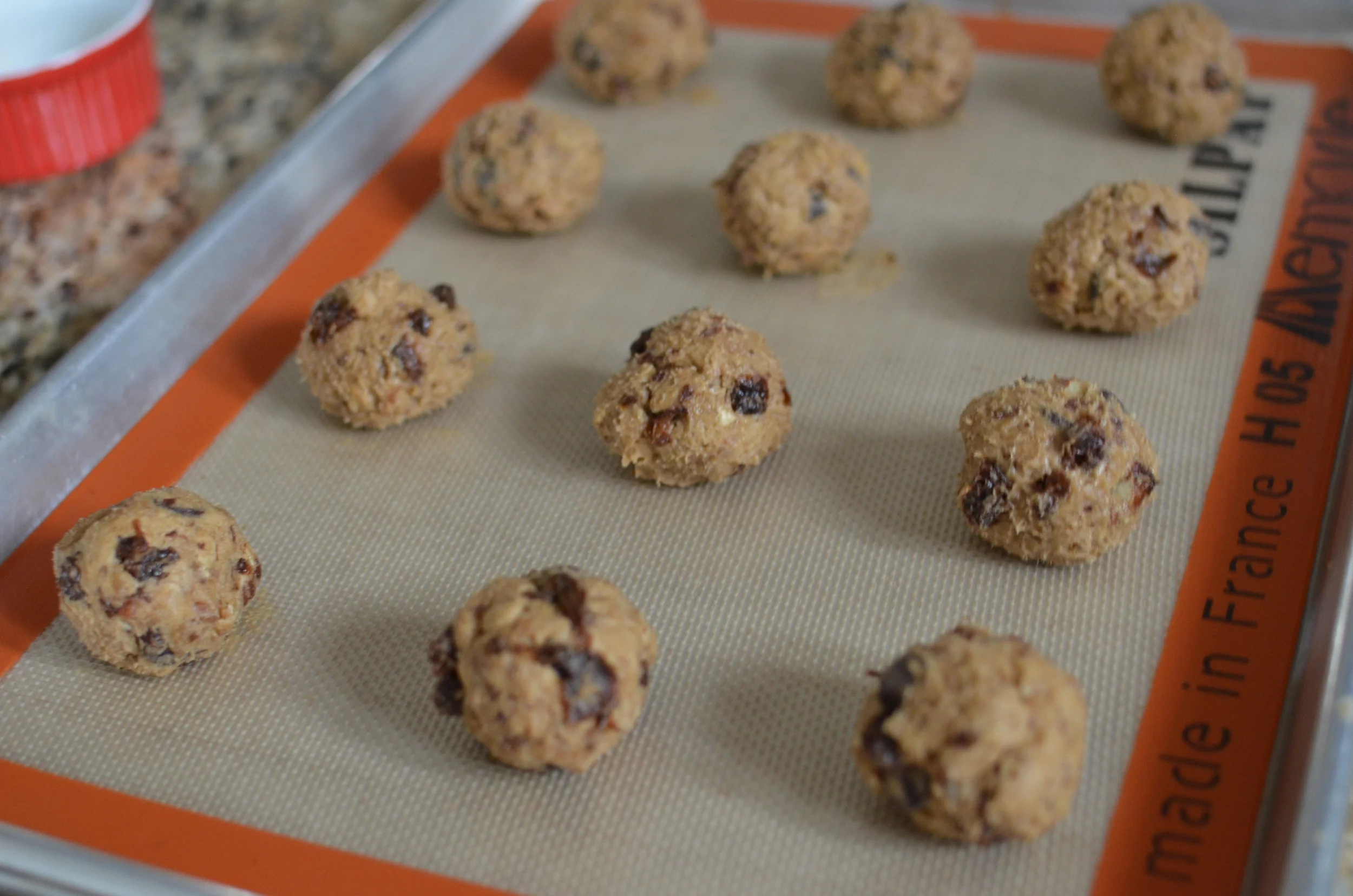 Roll the dough into balls. The dough is sticky so I wet my hands with a little water to make rolling easier.