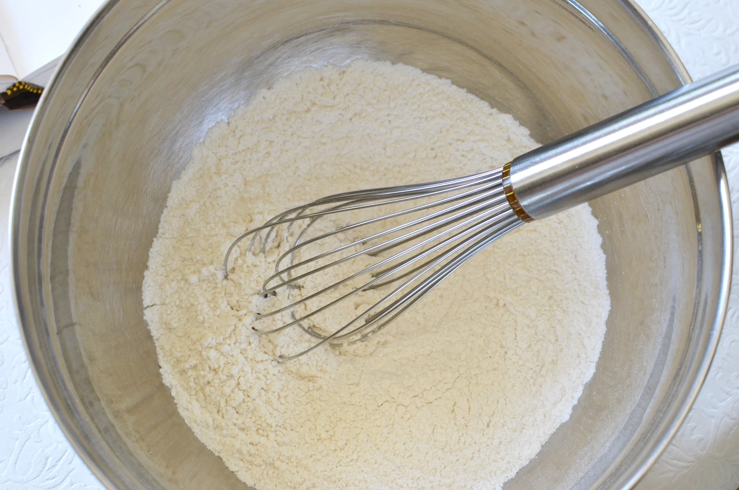 For this recipe, whisk together the dry ingredients. Flour, baking powder, salt, and sugar.