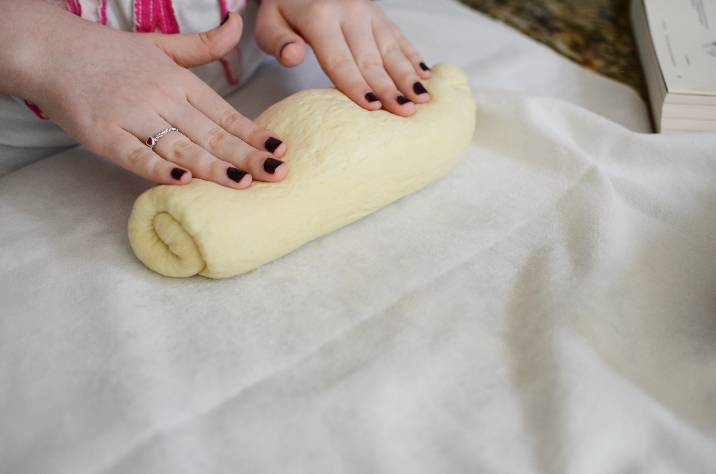 Then the dough is rolled into a log using gentle pressure with both hands.