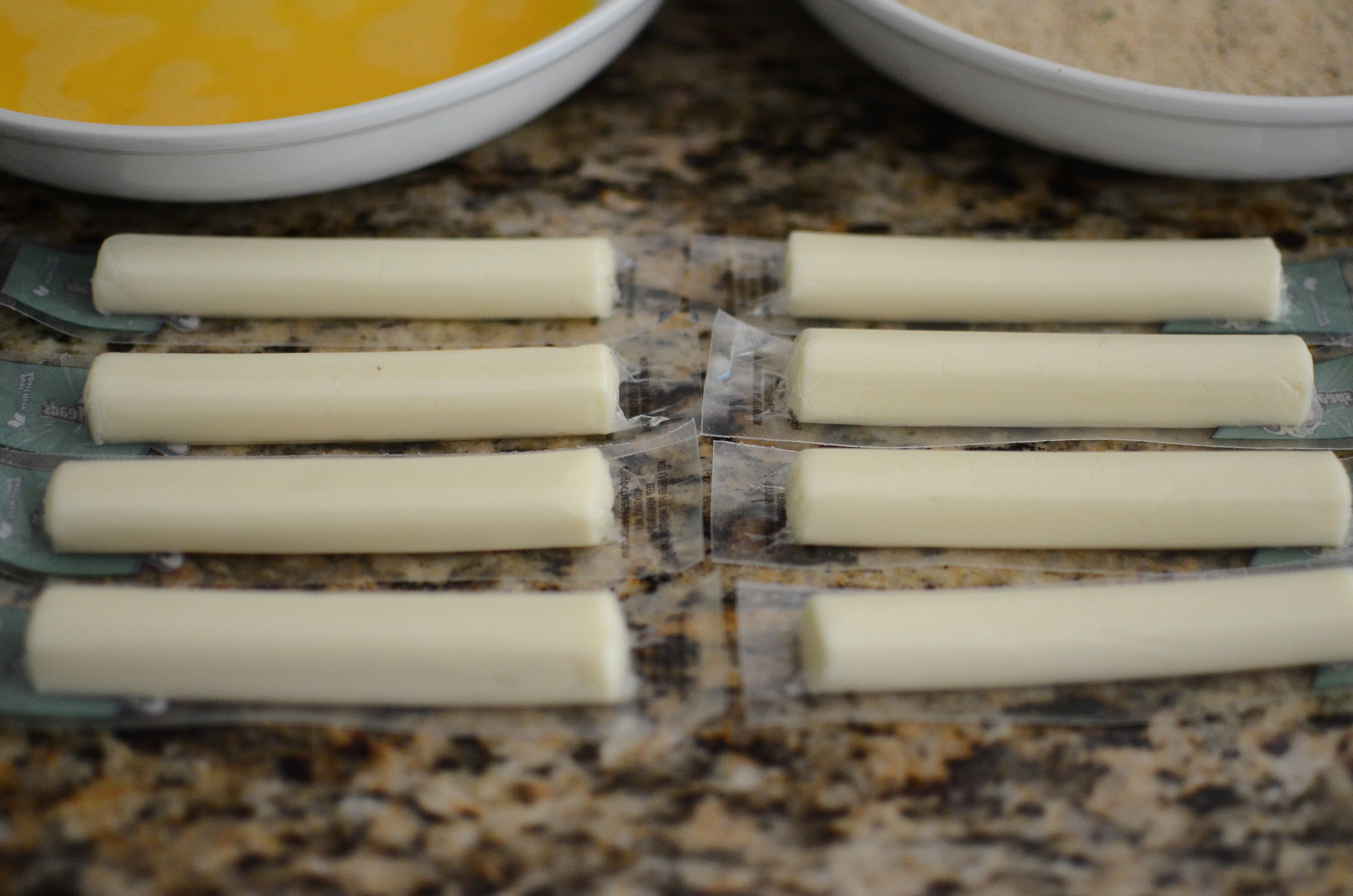 For this recipe, you'll need low-moisture mozzarella cheese. You can purchase a block of cheese and cut it up, or you can make it easy on yourself and buy individually wrapped string cheese. They're the perfect size and shape. 