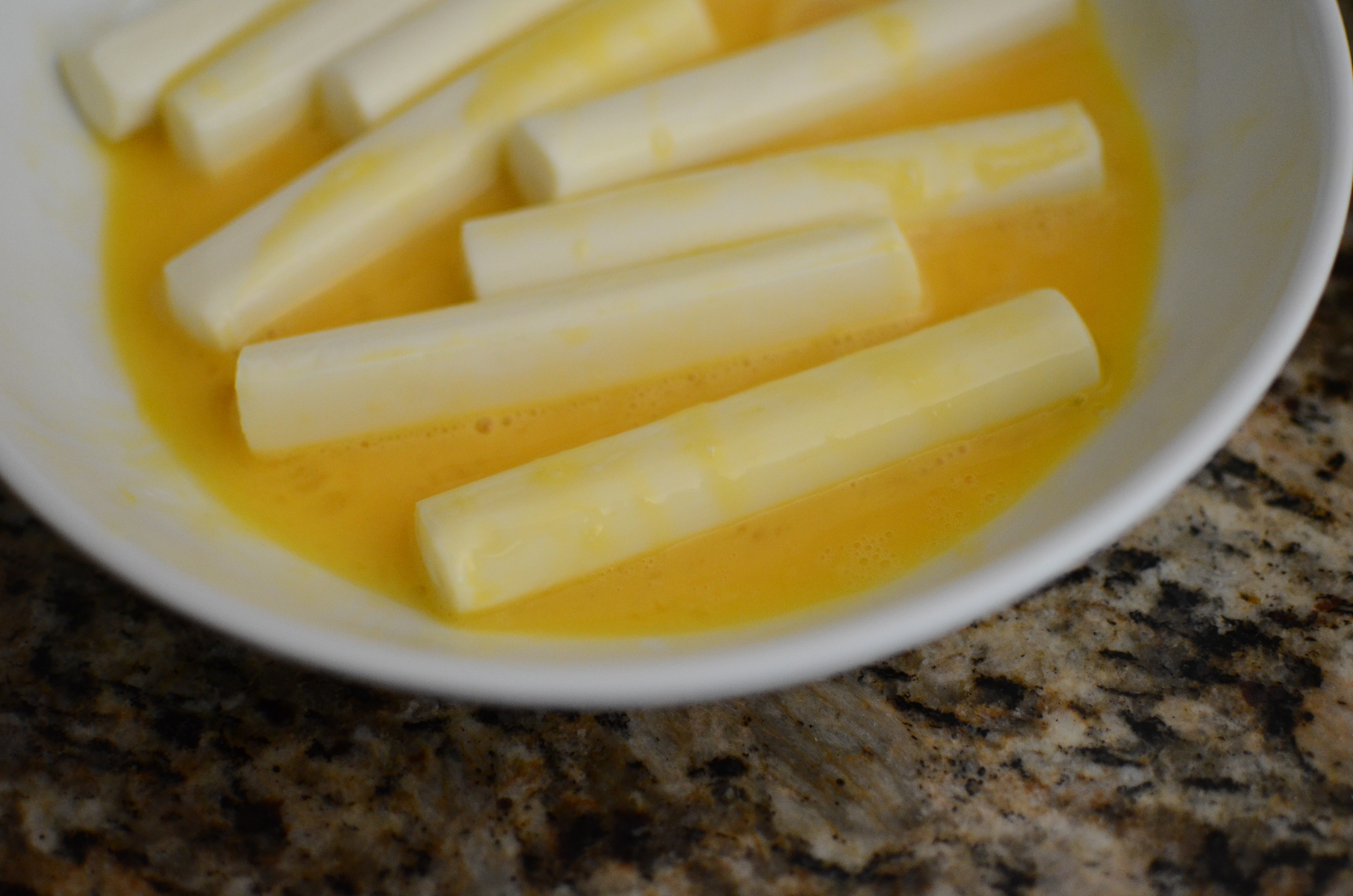 Dip the string cheese in beaten eggs.