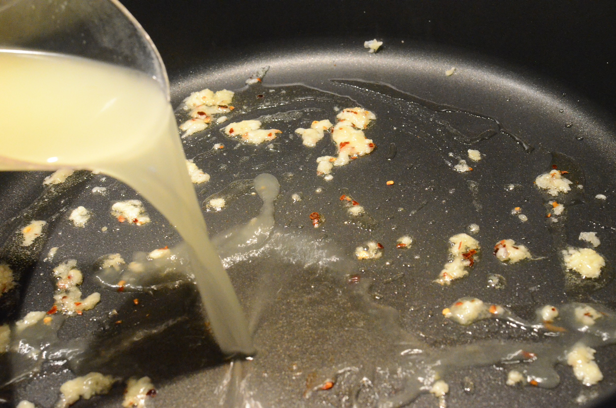 That's when you'll add the chicken stock. Give everything a quick stir.