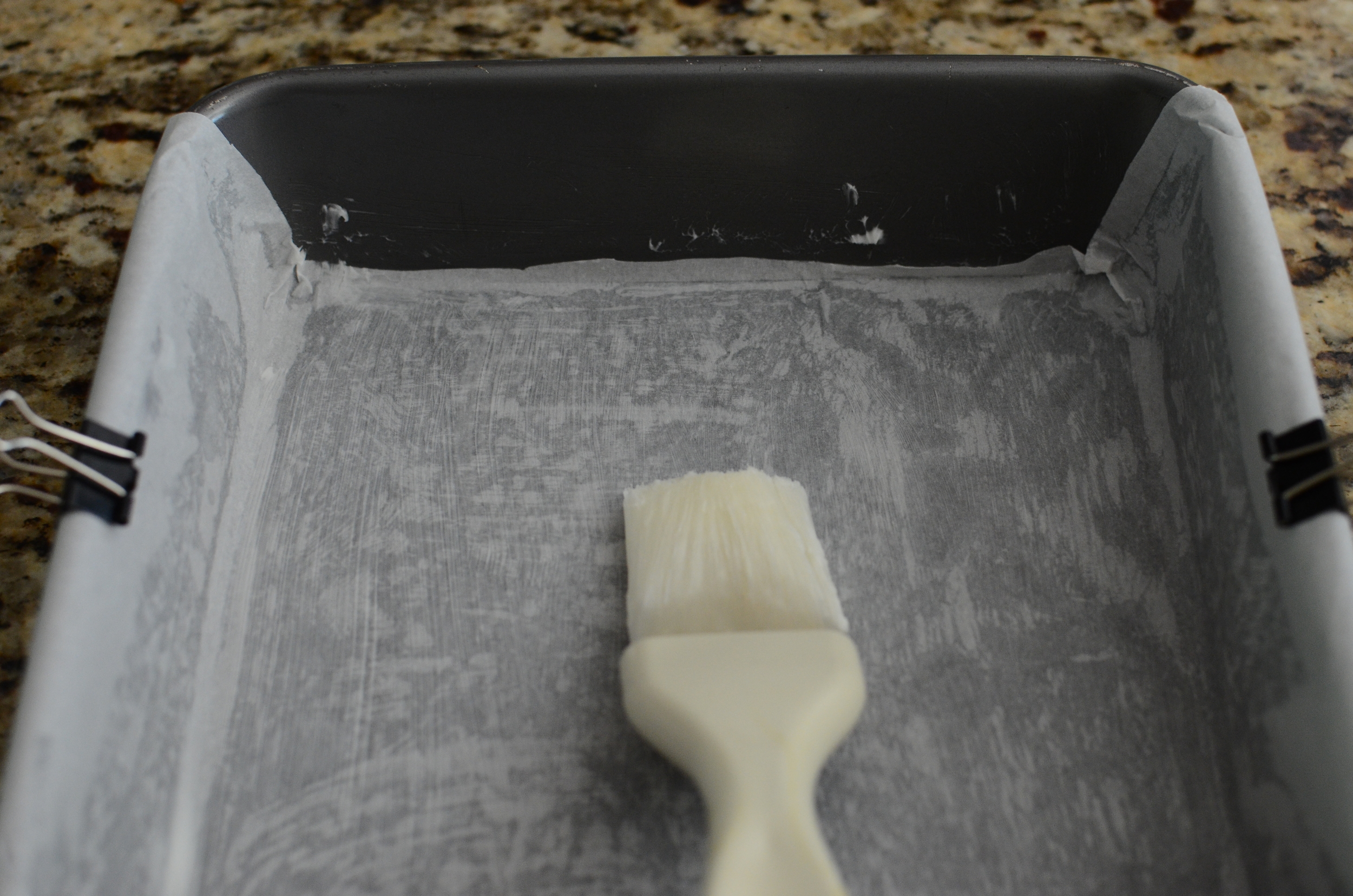 Now brush more shortening on top of the parchment to glue a 2nd strip crossing over in the other direction. 