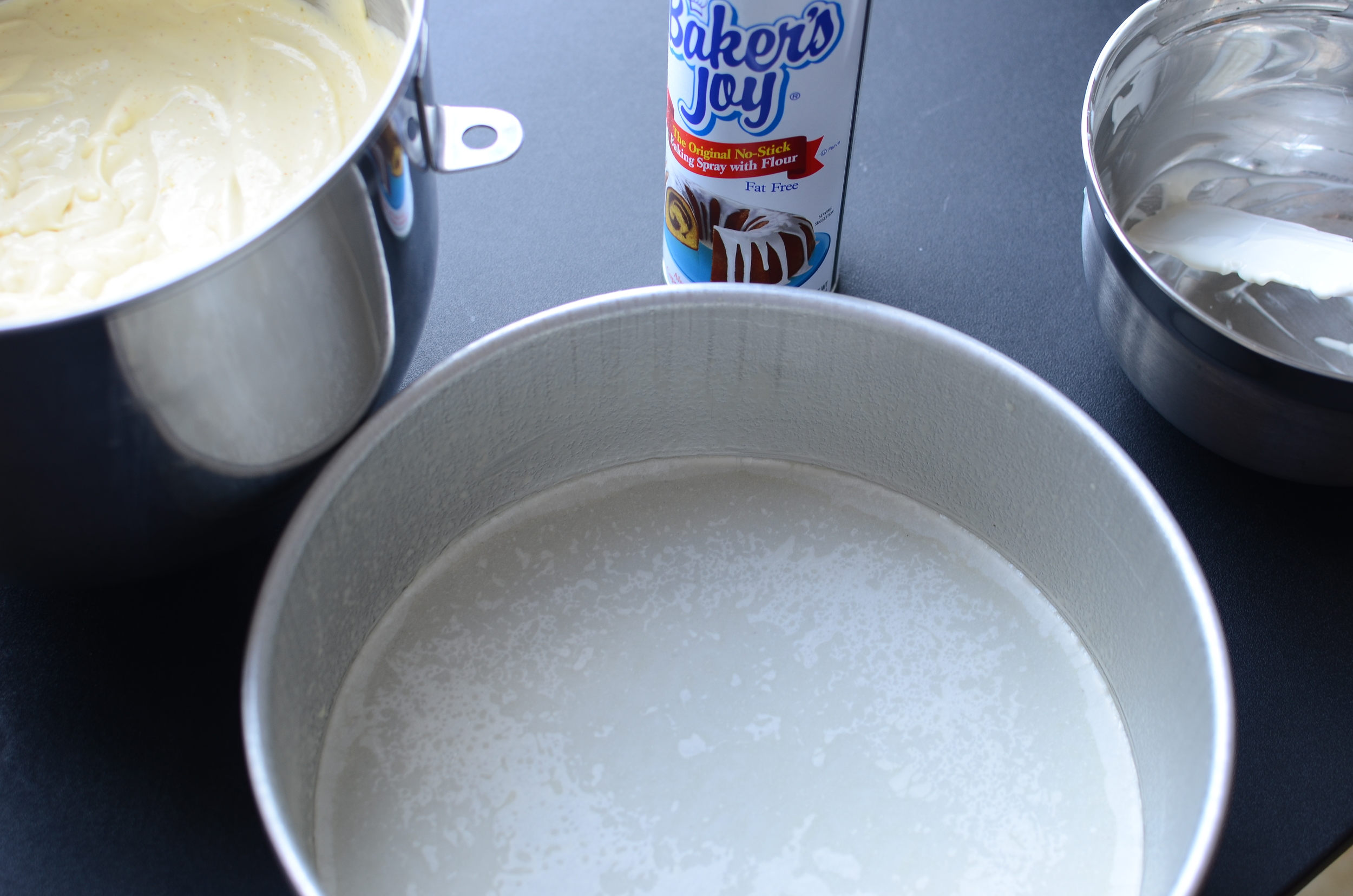 Since I opted to not make the cake base, I thought it would be better to use a 3-inch deep water-tight push pan or round cake pan instead of a springform pan because liquid has a tendency to leak out of the bottom of springform pans. To ensure easy removal of my baked cheesecake, I sprayed my pan with Baker's Joy and lined the bottom of the pan with parchment paper .