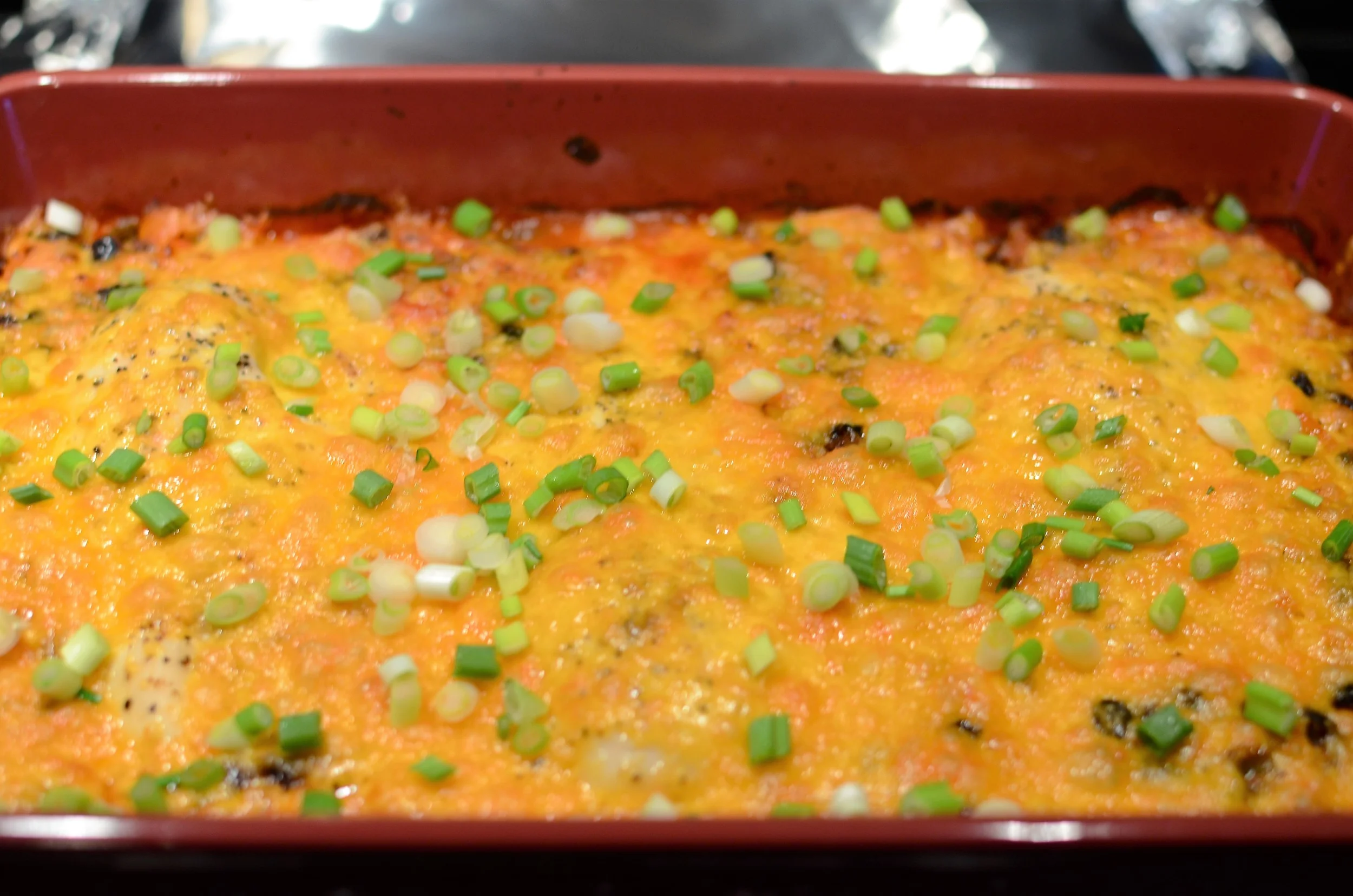 Remove from the oven, sprinkle with chopped scallions, and serve. 