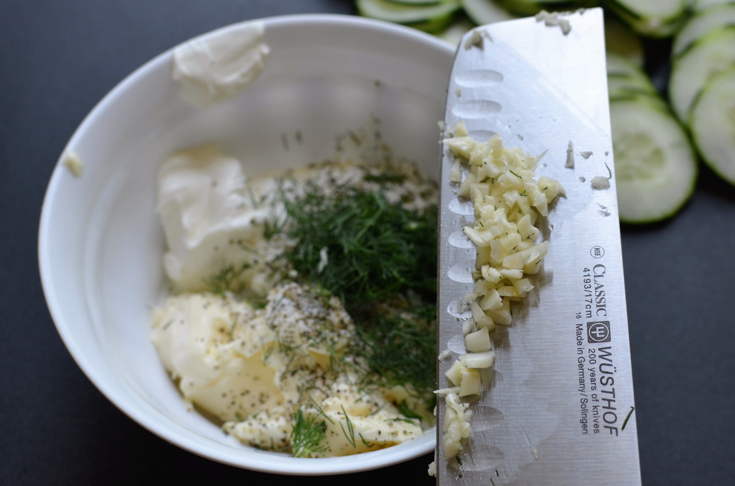 how to make the dressing for cucumber salad usuing plain greek yogurt or sour cream, mayo, fresh dill, minced fresh garlic, salt and pepper.