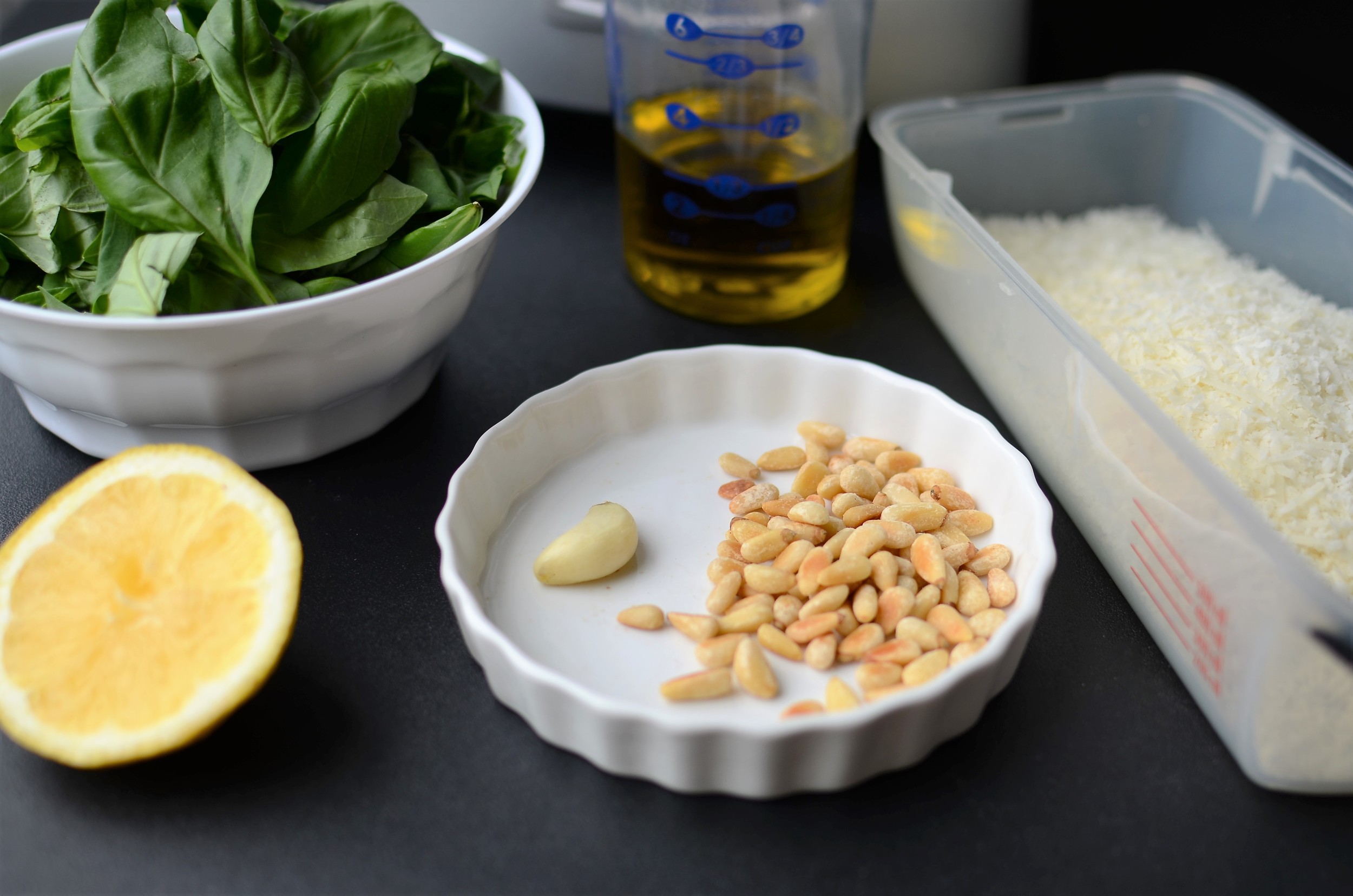 Let's make PESTO! basil, extra virgin olive oil, grated parmesan or romano cheese, fresh lemon juice, toasted garlic, and toasted pine nuts.